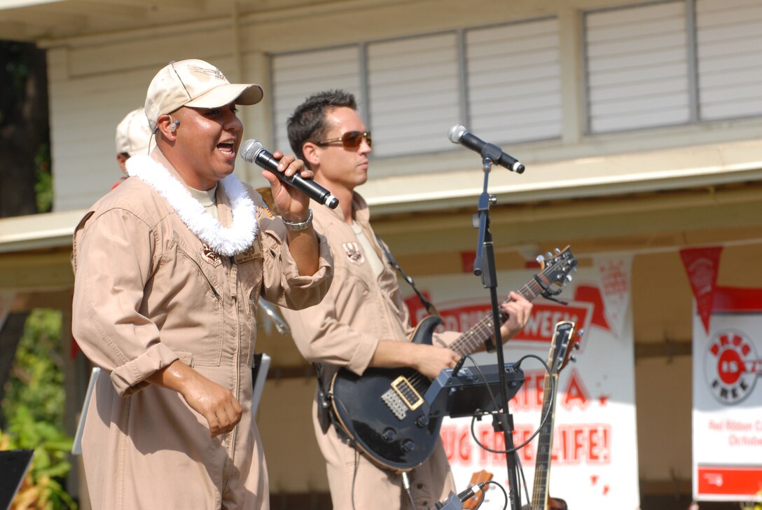 HICKAM AIR FORCE BASE, Hawaii -- Tech. Sgt. Richard Vasquez, U.S. Air Force Band of the Pacific vocalist, sings to a crowd of Hickam Elementary School students here, Oct. 29. Hickam, one of two elementary schools on base, was one of six schools the band performed for in support of Red Ribbon Week. Red Ribbon Week focuses on living and maintaining a drug free lifestyle. (U.S. Air Force photo/Senior Airman Gustavo Gonzalez)