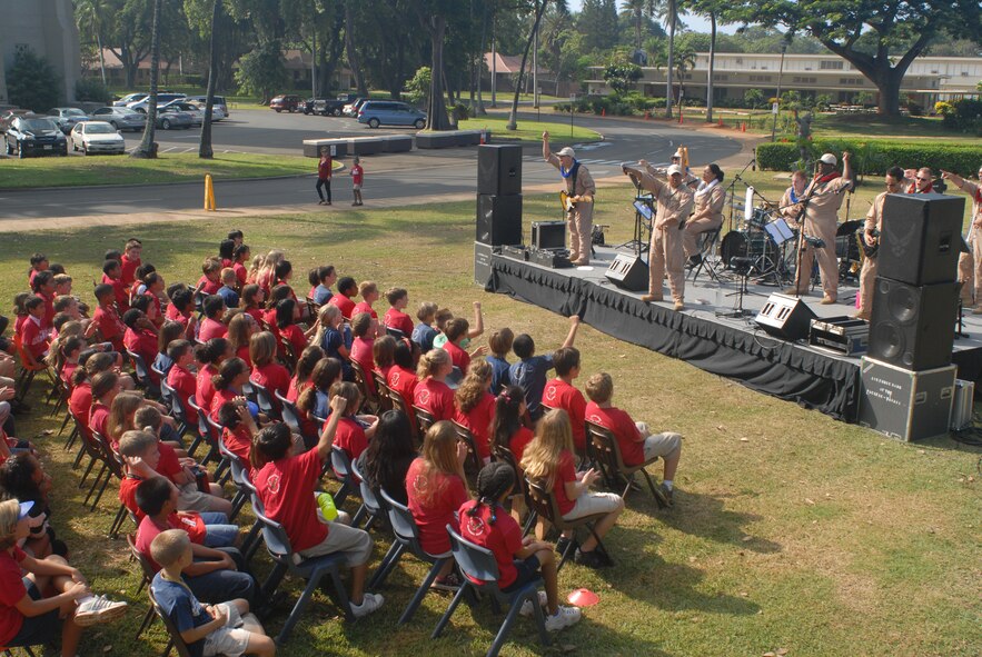 HICKAM AIR FORCE BASE, Hawaii -- The U.S. Air Force Band of the Pacific performs for a crowd of Hickam Elementary School students here, Oct. 29. Hickam, one of two elementary schools on base, was one of six schools the band performed for in support of Red Ribbon Week. Red Ribbon Week focuses on living and maintaining a drug free lifestyle. (U.S. Air Force photo/Senior Airman Gustavo Gonzalez)