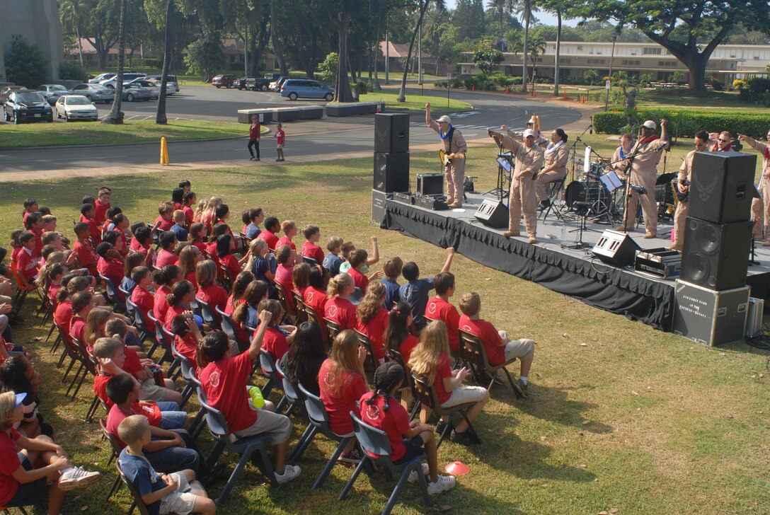 HICKAM AIR FORCE BASE, Hawaii -- The U.S. Air Force Band of the Pacific performs for a crowd of Hickam Elementary School students here, Oct. 29. Hickam, one of two elementary schools on base, was one of six schools the band performed for in support of Red Ribbon Week. Red Ribbon Week focuses on living and maintaining a drug free lifestyle. (U.S. Air Force photo/Senior Airman Gustavo Gonzalez)