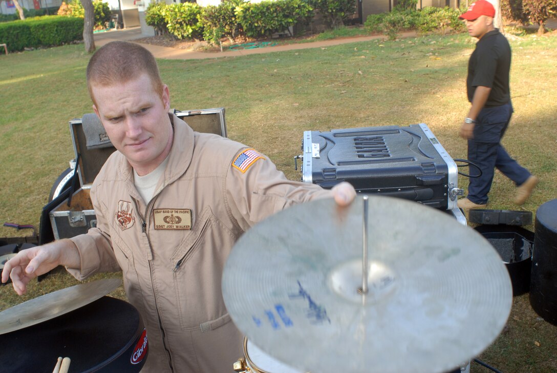 HICKAM AIR FORCE BASE, Hawaii -- Staff Sgt. Jody Walker, U.S. Air Force Band of the Pacific drummer, sets up his drums before performing for Hickam Elementary School students here, Oct. 29. Hickam, one of two elementary schools on base, was one of six schools the band performed for in support of Red Ribbon Week. Red Ribbon Week focuses on living and maintaining a drug free lifestyle. (U.S. Air Force photo/Senior Airman Gustavo Gonzalez)