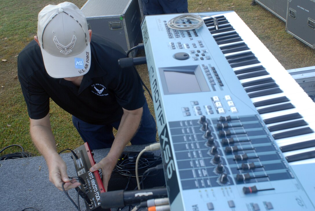 HICKAM AIR FORCE BASE, Hawaii -- Master Sgt. Daryl Yager, U.S. Air Force Band of the Pacific key boardist, sets up his keyboard before performing for Hickam Elementary School students here, Oct. 29. Hickam, one of two elementary schools on base, was one of six schools the band performed for in support of Red Ribbon Week. Red Ribbon Week focuses on living and maintaining a drug free lifestyle. (U.S. Air Force photo/Senior Airman Gustavo Gonzalez)