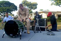 HICKAM AIR FORCE BASE, Hawaii -- Staff Sgt. Jody Walker, U.S. Air Force Band of the Pacific drummer, sets up his drums before performing for Hickam Elementary School students here, Oct. 29. Hickam, one of two elementary schools on base, was one of six schools the band performed for in support of Red Ribbon Week. Red Ribbon Week focuses on living and maintaining a drug free lifestyle. (U.S. Air Force photo/Senior Airman Gustavo Gonzalez)