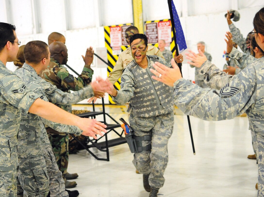 Chief Master Sgt. Robin Johnson, 11th Wing command chief, rallies the crowd upon entrance to the Joint Base Andrews Naval Air Facility Washington Enlisted Combat Dining Out in Hangar 3 Oct. 23. Chief Johnson was the guest speaker for the dining out and spoke on issues affecting enlisted Airmen. (U.S. Air Force photo/ Staff Sgt. Keyonna Fennell)
