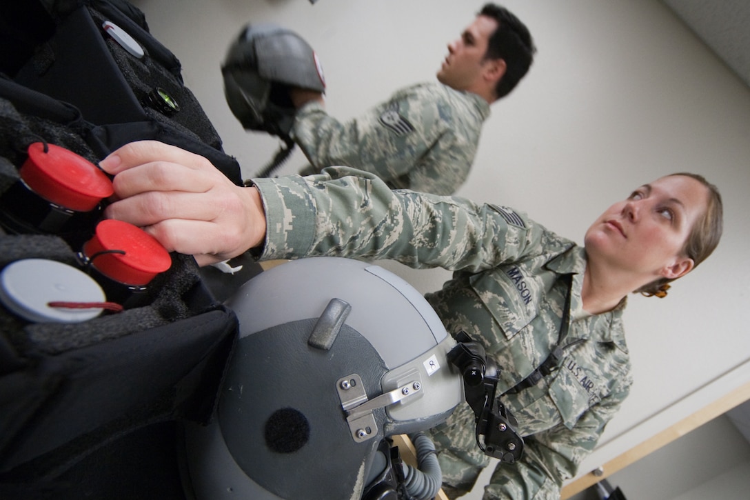 Air Force Tech. Sgt. Sheron Mason and Staff Sgt. Jessie McCarley, from the 121st Fighter Squadron’s Aircrew Flight Equipment section, inspect night vision equipment for a night-flying exercise at Davis-Monthan Air Force Base, Tucson, AZ, November 21, 2009. The 121FS, D.C. Air National Guard, is receiving two weeks of training in preparation for an upcoming Aerospace Expeditionary Force deployment in 2010. (U.S. Air Force photo by Staff Sgt. Gareth Buckland/Released).
