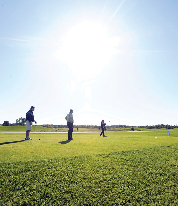 William Martin, right, tees off while teammates Adam Fitch, center, and Joshua Cherkinsky, left, wait their turn. The three 316th Comptroller Squadron members took part in the Air Force District of Washington Golf Tournament hosted by The Courses at Andrews Oct. 19. (U.S. Air Force photo/ Staff Sgt. Steven Doty)