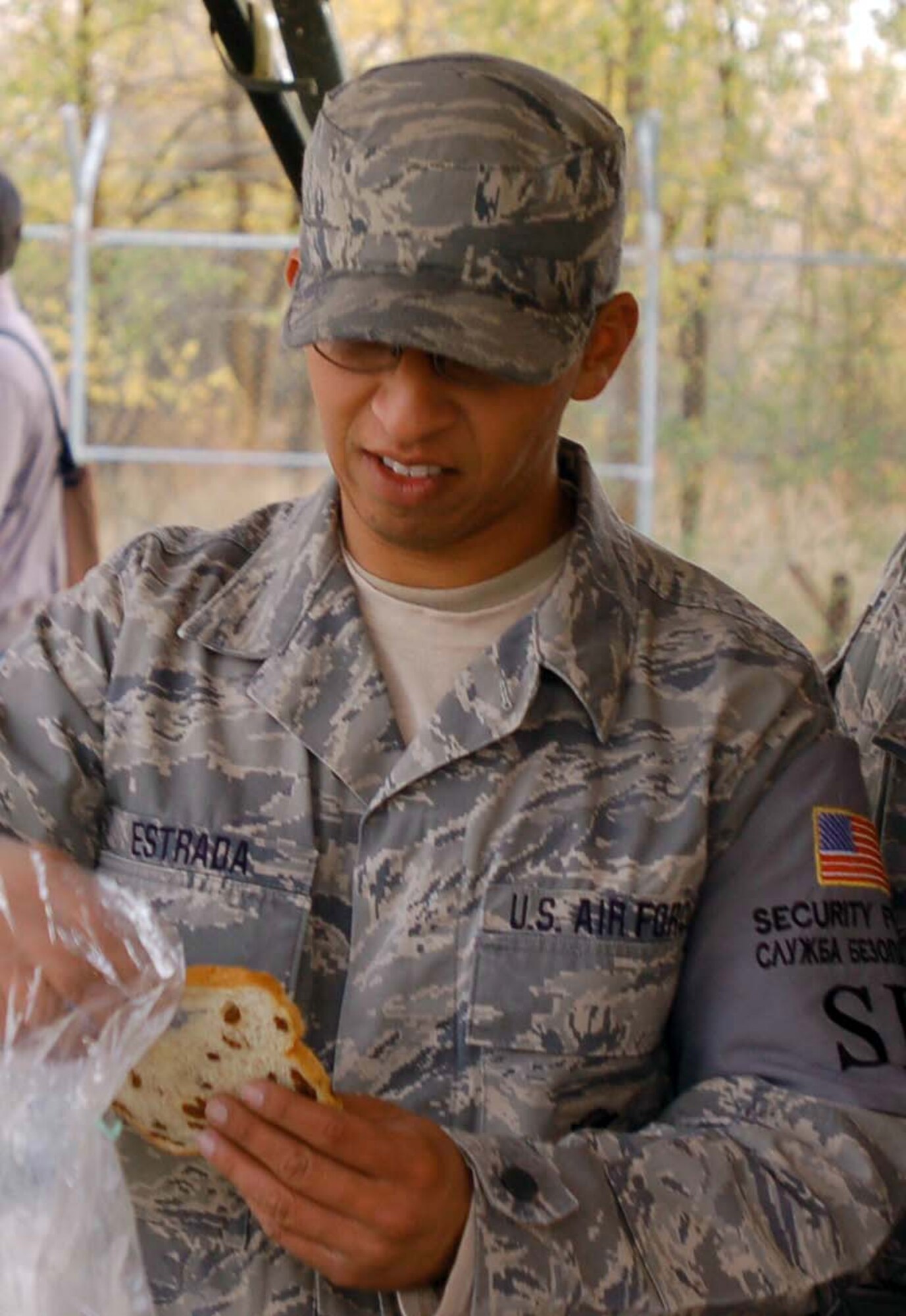 Staff Sgt. Jake Estrada tastes a sample of raisin bread during the first delivery of local Kyrgyz produce and breads Oct. 27, 2009, at the Transit Center at Manas, Kyrgyzstan. The delivery was part of the steps Airmen here are making to support more local businesses. Sergeant Estrada is assigned to the 376th Expeditionary Security Forces Squadron. (U.S. Air Force photo/Chief Master Sgt. James Dowell)