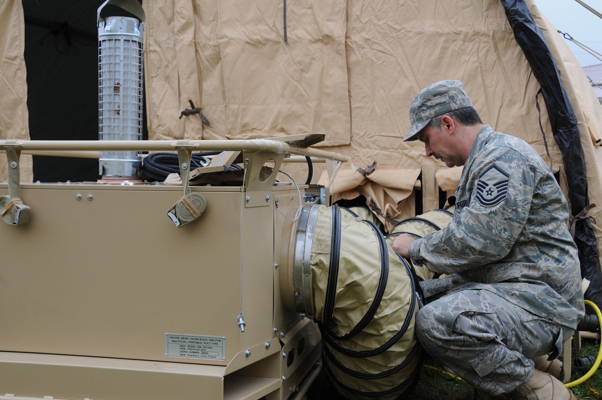 Master Sgt. Thomas Pilarz, 107th AW, Civil engineering Squadron prepares a self contained mobile heater for use. The heating system is complete with duct work, thermostat and a carbon monoxide detector.   The heaters are part of a new system that is being set up to provide temporary housing for Vigilant Guard military responders. (USAF Photo/SSgt. Peter Dean)