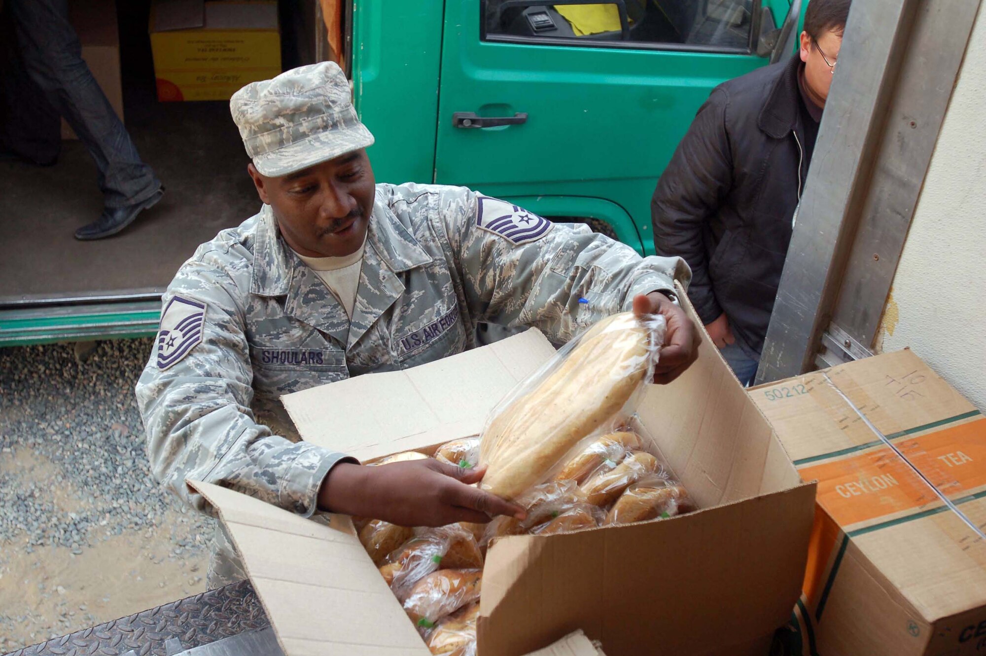 Master Sgt. John Shoulars opens a box of fresh bread during the first delivery of local farm products Oct. 27, 2009, at the Transit Center at Manas, Kyrgyzstan. The delivery was part of the steps Airmen here are making to support more local businesses. Sergeant Shoulars is the sustainment flight chief for the 376th Expeditionary Force Support Squadron. (U.S. Air Force photo/Chief Master Sgt. James Dowell)