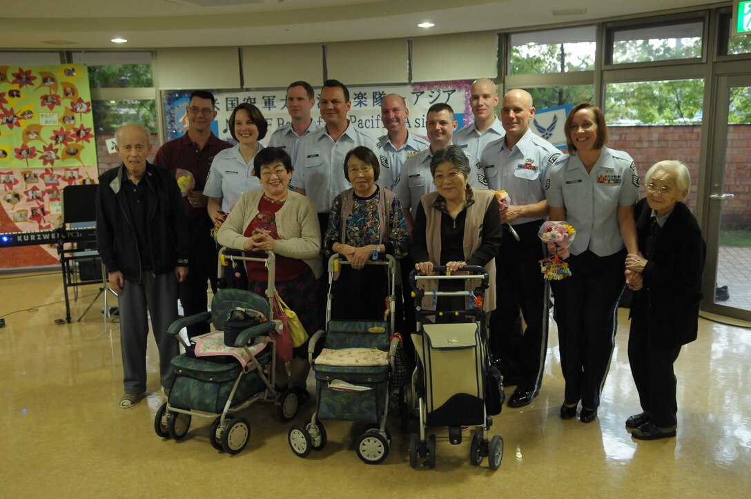10/15/2009 – Hiroshima, Japan – They’ve played before select crowds before – heads of state, military leaders and the like.  But, for the members of the U.S. Air Force Band of the Pacific-Asia, the crowd at the Oct. 14 show in southern Japan was not only exclusive, but held special meaning for the performers.  The band, five days into a 10-day tour, played before 100 residents of the Yano Orizuru-en nursing home in Hiroshima.  Constructed only three years ago, the one-of-kind home’s residents are all survivors of the Aug. 6, 1945, atomic bomb attack on Hiroshima.  Residents range in age from 66 to 107 years and there’s a waiting list of nearly 2,000 to get into the facility.  “The patients were all very welcoming to us,” said Tech. Sgt. Gary Rosenak, U.S. Air Force Band of the Pacific-Asia guitarist.  “It made us feel good to do something like this for them.”  The patients as well as the staff of the nursing home were very thankful and appreciative of the band and their music, according to Nobua Murata, chief of the nursing home.  Following the performance, a few audience members presented gifts of thanks to band members.  “We rarely get opportunities to listen to live music, and we enjoyed it very much,” said Mr. Murata.  “It  was also the first time the band has come to play here for us, which was also a huge honor.”  Band members said they felt honored to perform at the home and wanted to show the patients respect for what they had gone through, according to Sergeant Rosenak.  “We want to keep building our relationship with them,” he said.  “We would be honored to perform again if they invited us here in the future.”                
by Airman First Class Sean Martin                                                                                                                             374th Airlift Wing Public Affairs
