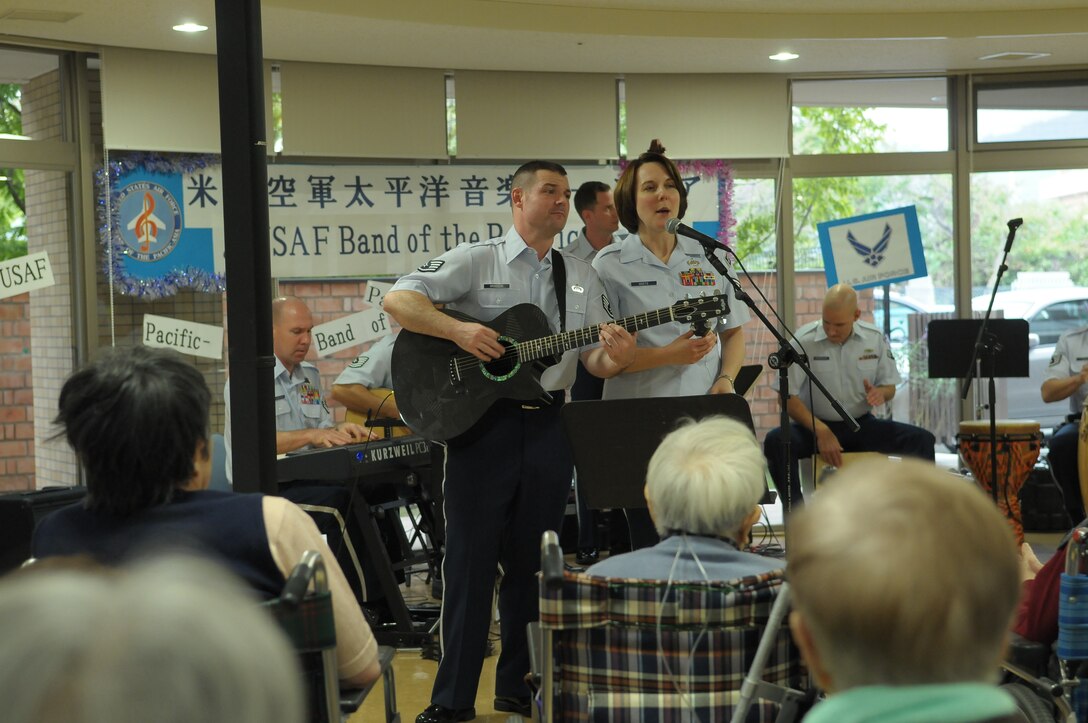 10/15/2009 – Hiroshima, Japan – They’ve played before select crowds before – heads of state, military leaders and the like.  But, for the members of the U.S. Air Force Band of the Pacific-Asia, the crowd at the Oct. 14 show in southern Japan was not only exclusive, but held special meaning for the performers.  The band, five days into a 10-day tour, played before 100 residents of the Yano Orizuru-en nursing home in Hiroshima.  Constructed only three years ago, the one-of-kind home’s residents are all survivors of the Aug. 6, 1945, atomic bomb attack on Hiroshima.  Residents range in age from 66 to 107 years and there’s a waiting list of nearly 2,000 to get into the facility.  “The patients were all very welcoming to us,” said Tech. Sgt. Gary Rosenak, U.S. Air Force Band of the Pacific-Asia guitarist.  “It made us feel good to do something like this for them.”  The patients as well as the staff of the nursing home were very thankful and appreciative of the band and their music, according to Nobua Murata, chief of the nursing home.  Following the performance, a few audience members presented gifts of thanks to band members.  “We rarely get opportunities to listen to live music, and we enjoyed it very much,” said Mr. Murata.  “It  was also the first time the band has come to play here for us, which was also a huge honor.”  Band members said they felt honored to perform at the home and wanted to show the patients respect for what they had gone through, according to Sergeant Rosenak.  “We want to keep building our relationship with them,” he said.  “We would be honored to perform again if they invited us here in the future.”                
by Airman First Class Sean Martin                                                                                                                             374th Airlift Wing Public Affairs