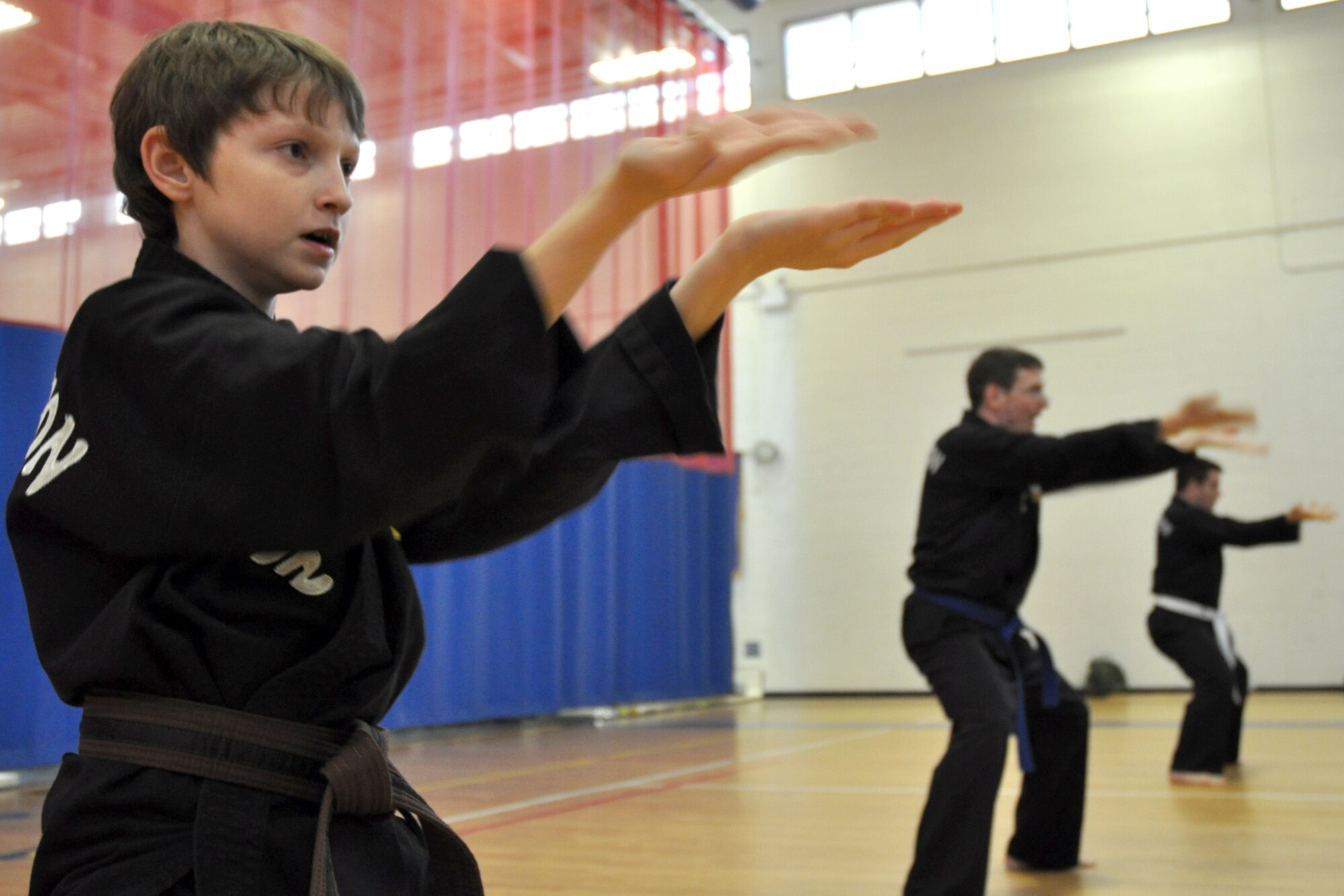 EGLIN AIR FORCE BASE, Fla. – Ryan, 11, and his father, Master Sgt. Kevin Schweitzer, 1st Special Operations Maintenance Squadron, master defense techniques during a Kuk Sool Won training session at the Eglin Fitness Center here. Kuk Sool encompasses many different “styles” of traditional martial arts and combines kicking, punching, throwing, falling, and joint-locking as well as a myriad of weapons techniques into a dynamic ‘hard-soft’ style, emphasizing speed and fluidity. (U.S. Air Force photo/ Airman 1st Class Anthony Jennings)