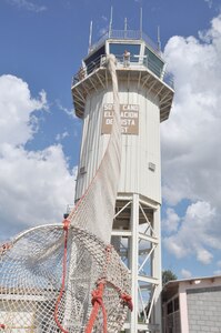 SOTO CANO AIR BASE, Honduras — Air traffic controllers and fire fighters from the 612th Air Base Squadron team up Oct. 29 to practice a bi-anual evacuation procedures at the base air traffic control tower using the Baker Life Chute. The Baker Life Chute was designed to give the controllers an expedient and safe means of getting down from the top of the tower (U.S. Air Force photo/Staff Sgt. Chad Thompson).