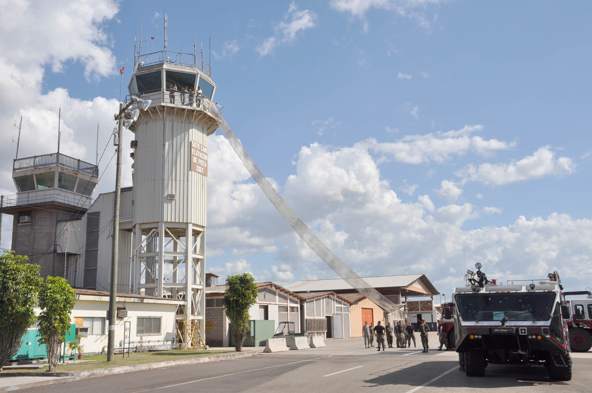 SOTO CANO AIR BASE, Honduras — Air traffic controllers and fire fighters from the 612th Air Base Squadron team up Oct. 29 to practice a bi-anual evacuation procedures at the base air traffic control tower using the Baker Life Chute. The Baker Life Chute was designed to give the controllers an expedient and safe means of getting down from the top of the tower (U.S. Air Force photo/Staff Sgt. Chad Thompson).