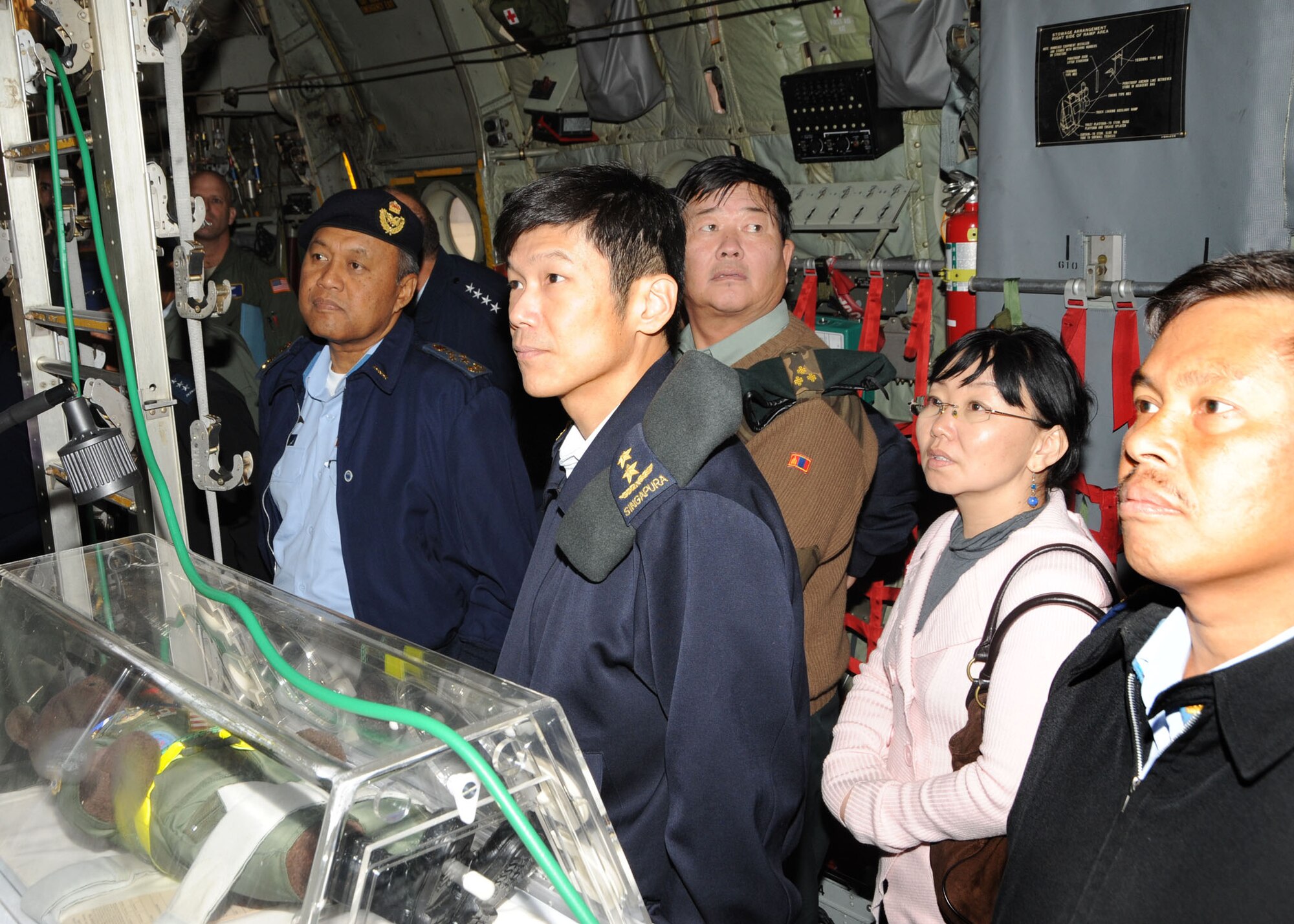Gen. Dato' Rodzali bin Daud, Chief of the Royal Malaysian Air Force; Maj.Gen. Ng Chee Kern, Chief of the Republic of Singapore Air Force; Col. Dashdeleg Tojoon, Commander, Mongolian Air Defense Force; and Col. Jofri Bin Haji Abdullah, Comander of the Royal Brunei Air Force, listen while aeromedical evacuation Airmen explain how they care for wounded servicemembers aboard aircraft during a visit to Air Mobility Command Headquarters at Scott Air Force Base Oct. 28.  Nine Pacific Air Chiefs visited AMC as part of a multi-stop tour consisting of several U.S. Air Force installations in an effort to continue to develop and enhance the relationship between the U.S. and other air forces. (U.S. Air Force photo/A1C Tristin English) 