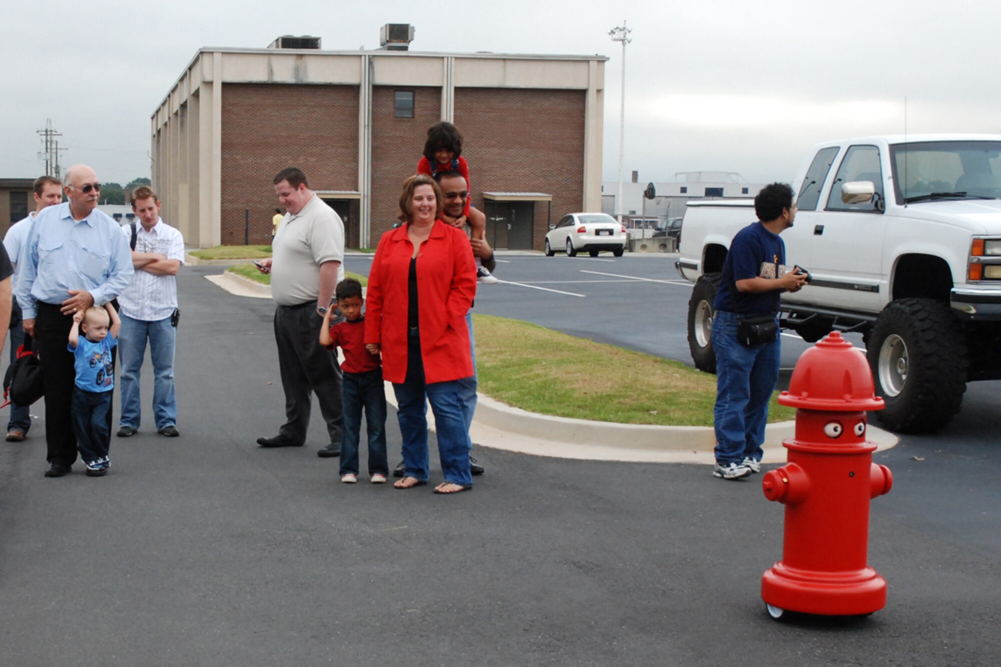 Members of the Georgia Tech University Flying Club, the Marcus Jewish Community Center of Atlanta and local residents view a fire prevention demomonstration by Pluggie, an interactive talking robot fire hydrant during a base tour Oct. 9. (U.S. Air Force photo/Tech. Sgt. James Branch)