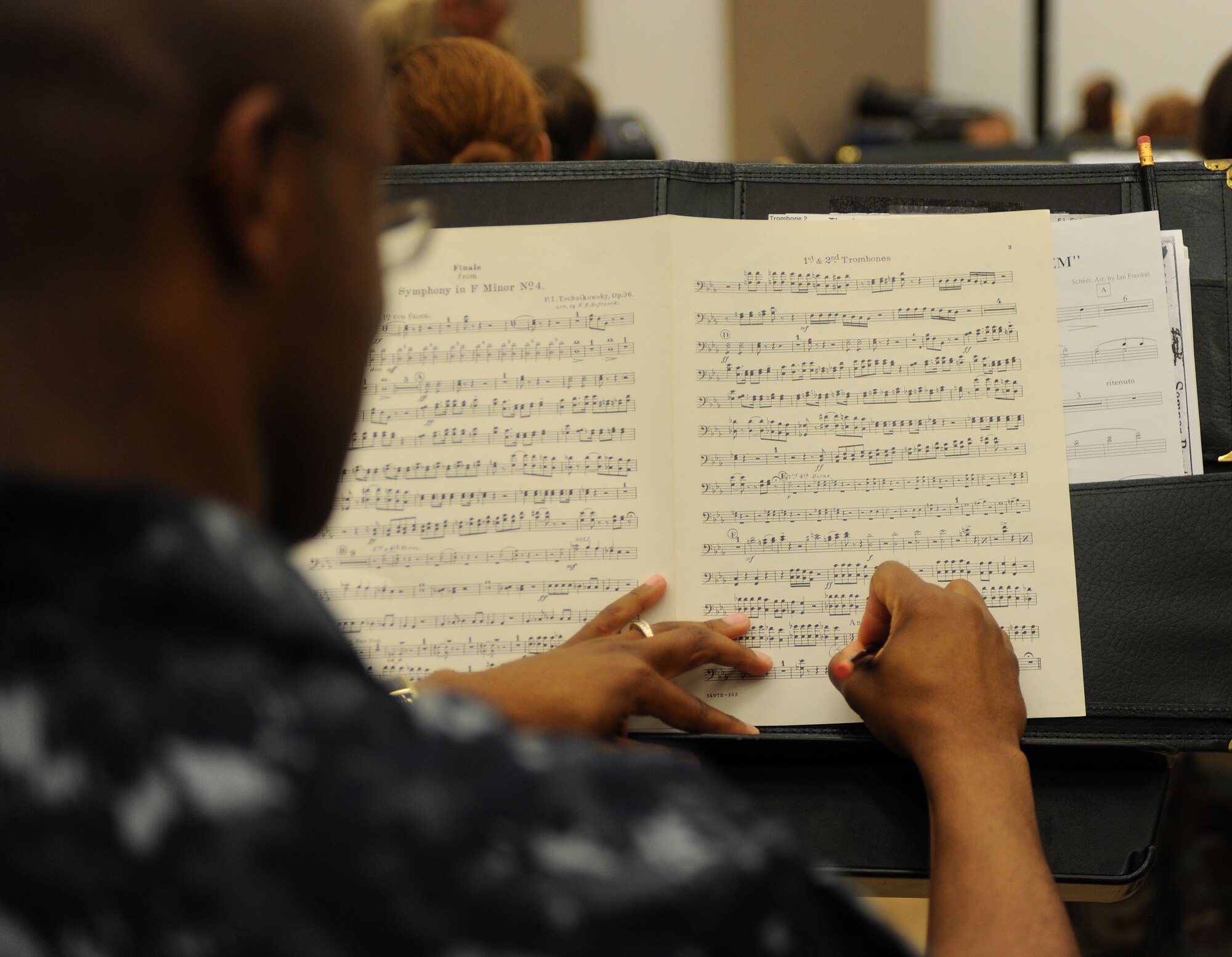 LANGLEY AIR FORCE BASE, Va. – A participant in the combined forces military band takes notes during a rehearsal here Oct. 29 in preparation for the 14th Annual "Salute to Veterans" concert, hosted by U.S. Joint Forces Command.  The concert is scheduled for Friday, Nov. 6, at the Chrysler Hall in Norfolk and is free and open to the public.  (U.S. Air Force photo/Airman Rebecca Montez))