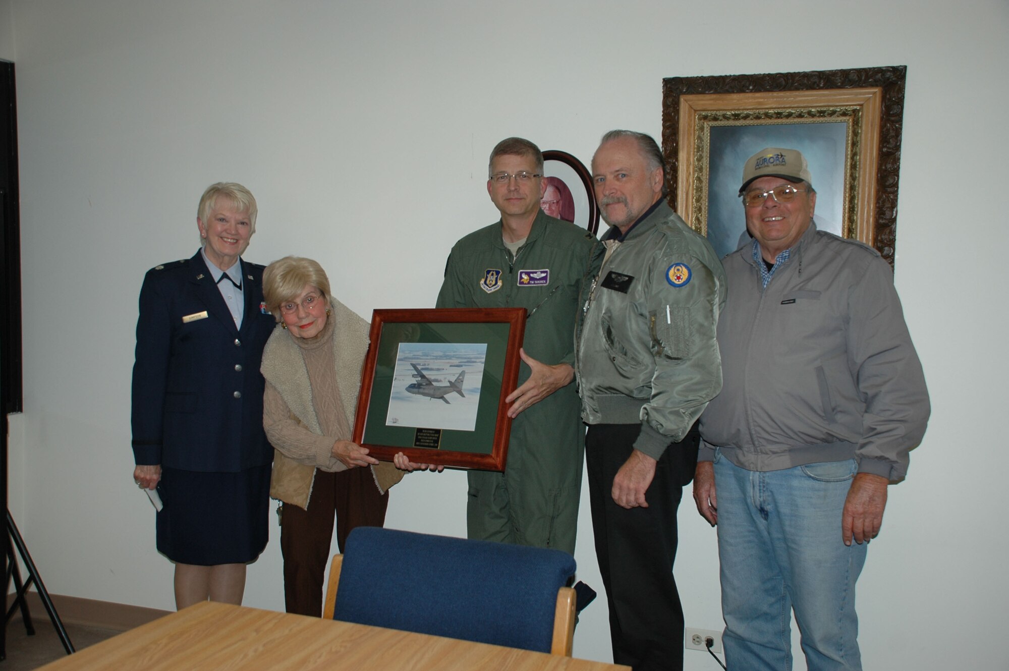 Col. Tim Tarchick, 934th Airlift Wing commander, and Troop Commander Lt. Col. Sharon Simpson, present (left to right) Ma Luman and sons, Bob and Mike Luman, with a framed 934th AW C-130 photo in appreciation for their support of the 934th AW shuttle operation in Aurora, Ill.  The Luman?s own the Fixed Base Operator location that provides a comfortable place near their homes for Reservists to catch the shuttle to the 934th AW from Illinois. (Air Force photo/Master Sgt. Darrell Habisch) 

