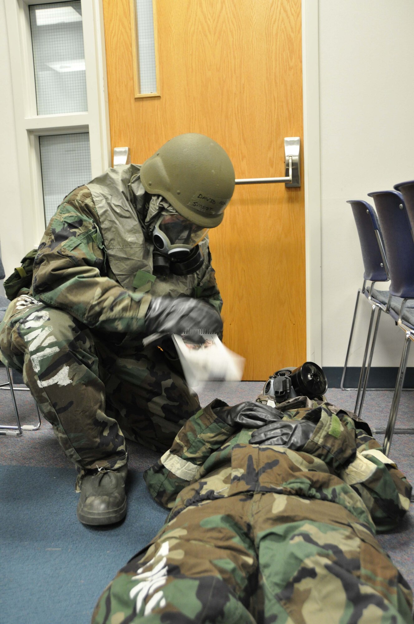 Senior Master Sgt. David Adrianson, performs self aid and buddy care on Senior Airman Shawn Ko. Both are members of the Aeromedical Staging Squadron. (Air Force photo/Tech. Sgt. Bob Sommer)
