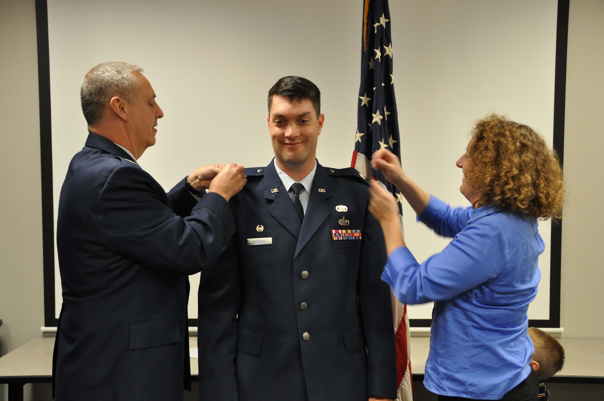 Lt. Col. Rick Erredge, 934th Communications Flight commander, has his new rank pinned on Oct. 4 by Col. Michael Ochs, 934th Mission Support Group commander, and his wife Katherine. (Air Force Photo/Tech. Sgt. Bob Sommer)
