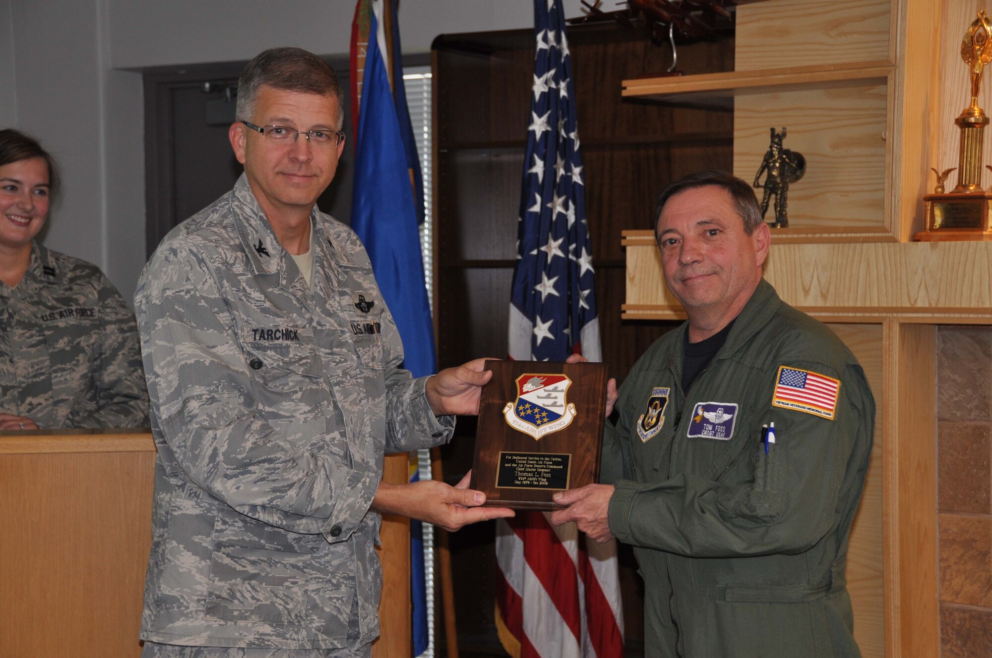 Chief Master Sgt. Tom Foss, 96th Airlift Squadron, receives his retirement plaque from Col. Tim Tarchick during his final UTA. The Chief retired with more than 36 years service. (Air Force Photo/Tech. Sgt. Bob Sommer)