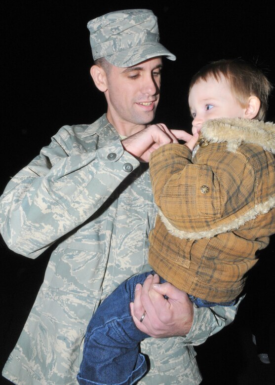 SPANGDAHLEM AIR BASE, Germany -- Staff Sgt. Derick Abel, 52nd Security Forces Squadron, is greeted by his wife, Gloria; daughters, 10-year-old Tiara (left) and 2-year-old Cina; and 10-month-old son, Anthony, here Oct. 27. Sergeant Abel returned from a six-month deployment to Bagram Airfield, Afghanistan, in support of Operation Enduring Freedom. (U.S. Air Force photo/Airman 1st Class Nick Wilson)
