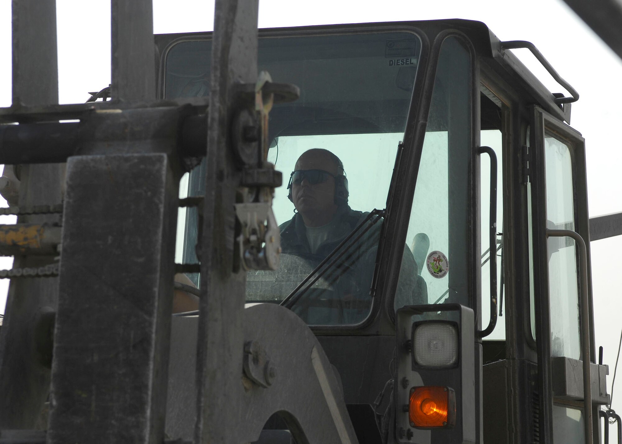 BAGRAM AIRFIELD, Afghanistan -- Tech. Sgt. Gordon Criswell, an air transportation specialist from the 455th Expeditionary Aerial Port Squadron, uses a forklift to remove materials from a K loader Oct. 30, 2009.  The 455th EAPS received multiple shipping containers, which can be used for anything from offices to living quarters.  Instead of having the shipping containers sit on the K loaders the Air Force, Army and civilian contractors teamed up and moved them to the Army's supply yard.  Sergeant Criswell is deployed from McGuire Air Force Base, N.J., and hails from Ocala, Fla.  (U.S. Air Force photo/Senior Airman Felicia Juenke)