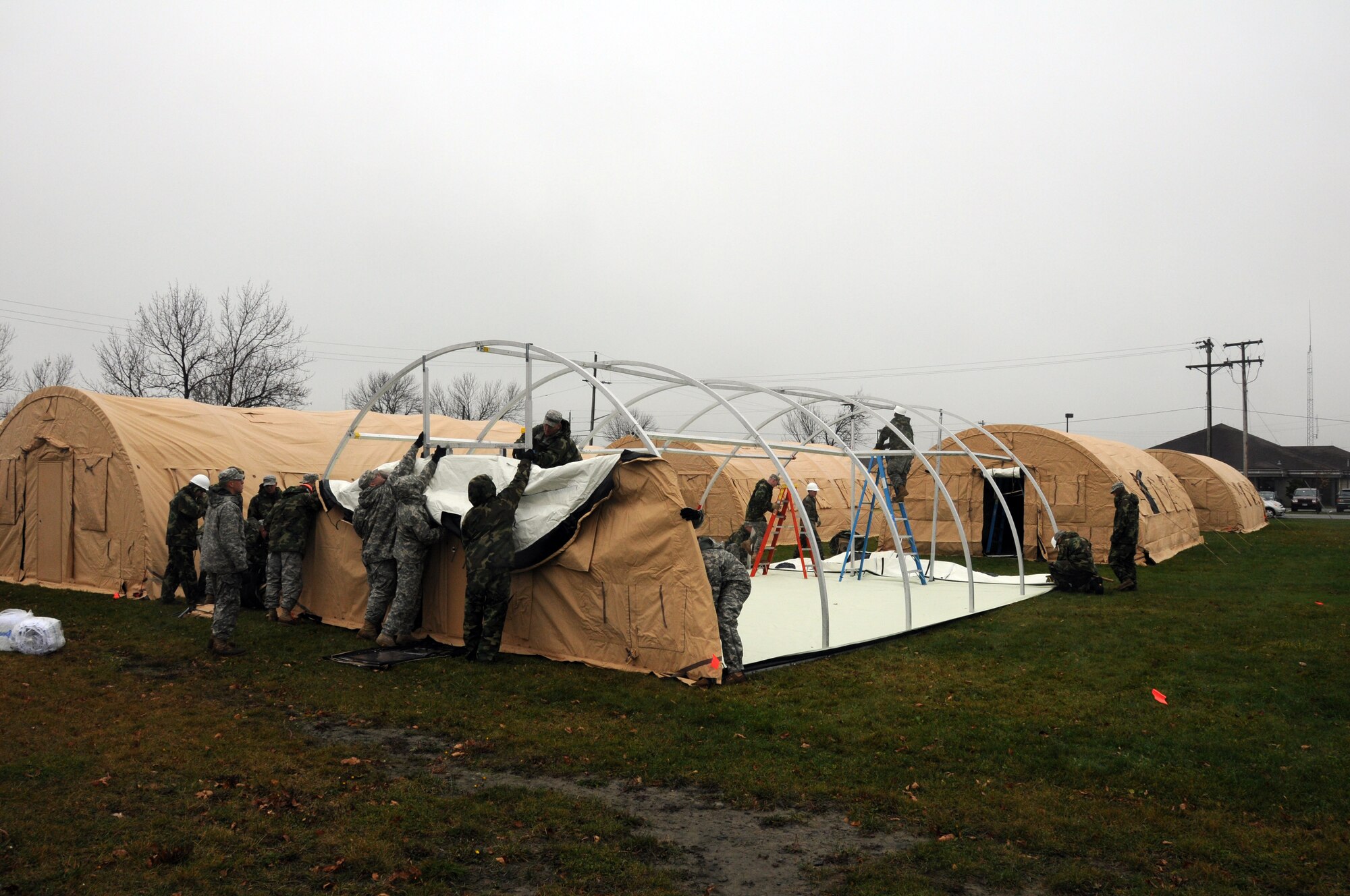 Niagara ramps up for Vigilant Guard. Civil engineers from the 107th Airlift Wing, work together with members from A Company 642nd, Army National Guard to construct a tent city. The work crew will erect 32 Rapid Deployment System shelters that will house up to 300 military responders. The RDS are highly mobile systems designed to be self contained temporary housing.  Each RDS comes complete with all necessary equipment to safely set up each shelter in a matter of a few hours. USAF Photo/Staff Sgt. Peter Dean.