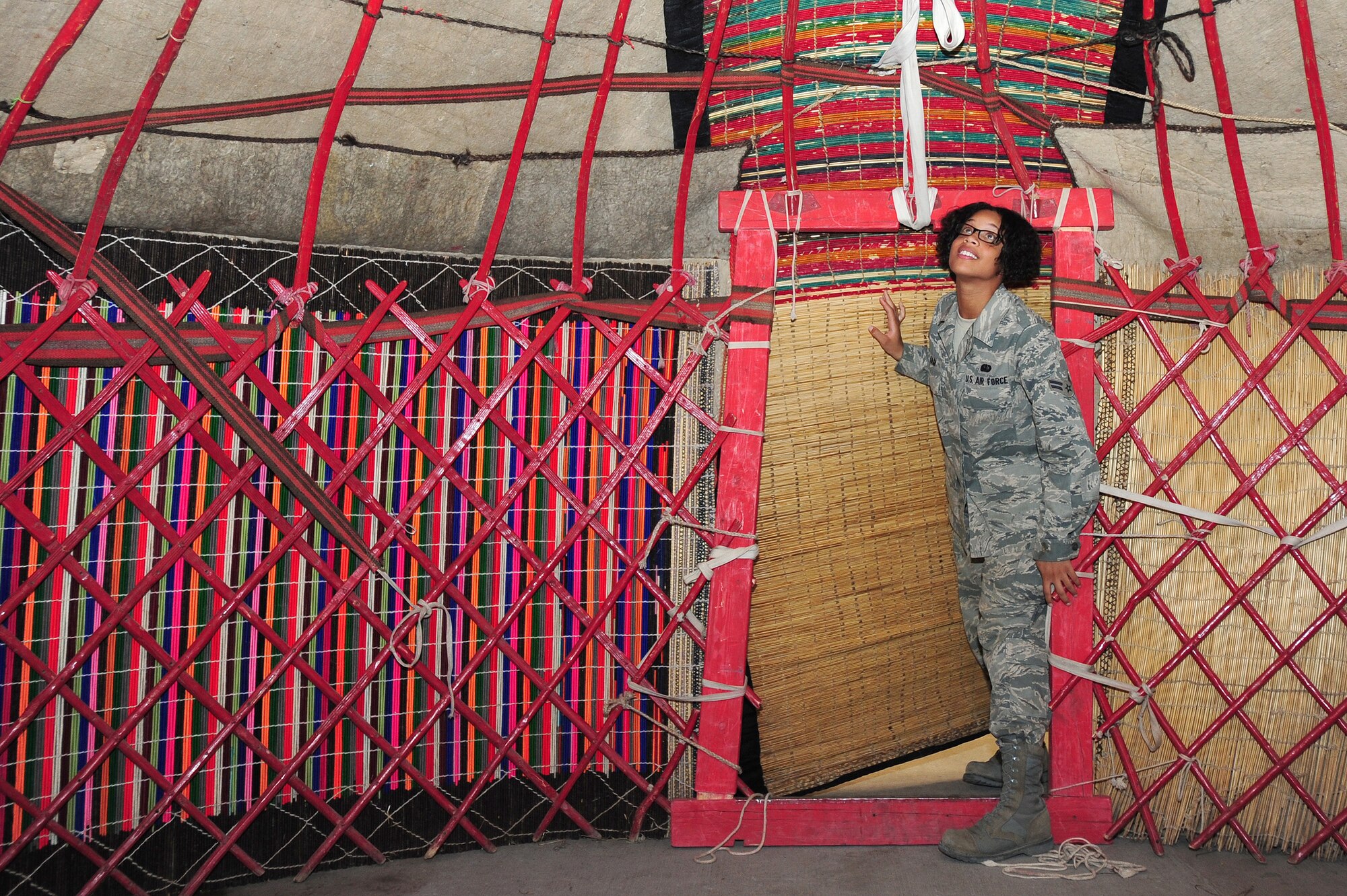 TRANSIT CENTER AT MANAS, Kyrgyzstan -- Airman 1st Class Mariah Ham, 376th Expeditionary Force Support Squadron quality assurance evaluator, takes a first at a fully-constructed Kyrgyz Yurt at the Transit Center as part of Kyrgyz Culture Day, Oct. 24, 2009. Airman Ham is deployed from the 43rd FSS at Pope Air Force Base, N.C. (U.S. Air Force photo/Senior Airman Steele C. G. Britton)