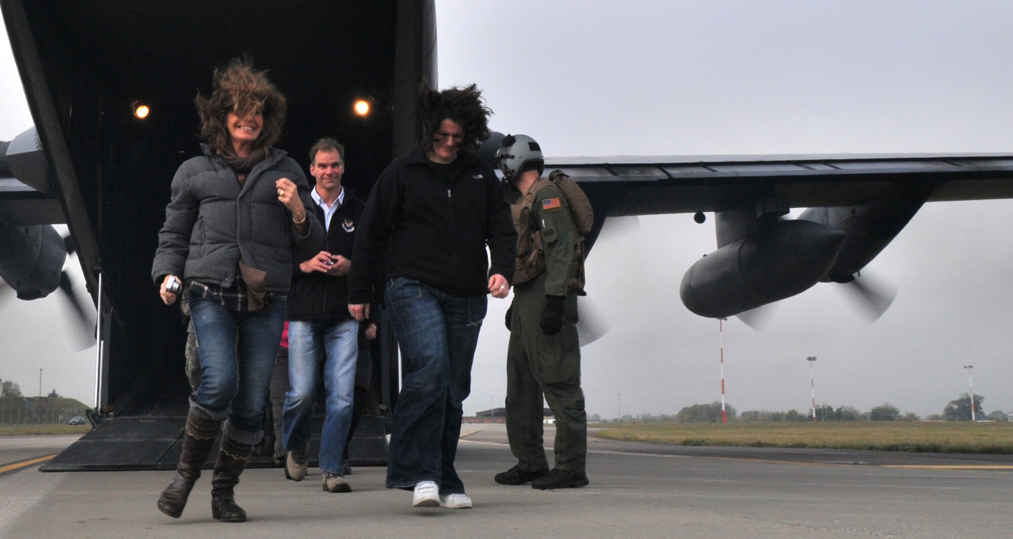 RAF MILDENHALL, England -- Barbara Cushing, Sal Davidson (front) and Hamish Ross (rear) expeditiously exit an MC-130H Combat Talon II at RAF Mildenhall Oct. 29. Ms. Cushing adn Mr. Ross were two among nearly five dozen participants in theTeam Mildenhall Honorary Commanders' Deployment Day. This was the first time the base has hosted such and event. (U.S. Air Force photo/Tech. Sgt. Kevin Wallace)

