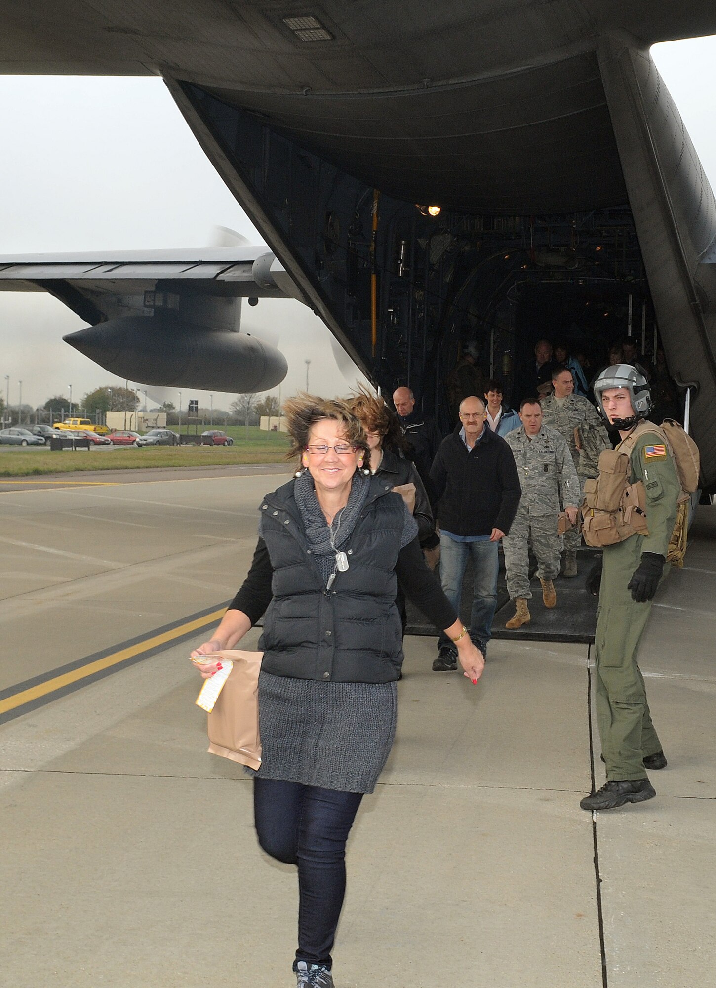 RAF MILDENHALL, England -- Team Mildenhall group and squadron commanders escort their honorary commanders and spouses out the back of an MC-130H Combat Talon II here Oct. 29. These were all participants of the Team Mildenhall Honorary Commanders' Deployment Day. After a morning of mobility training, the 60 participants boarded the aircraft to taxi across the flightline to a a mock Camp Kabul, Afghanistan, location. The event gave honorary commanders the opportunity to experience what military servicemembers do to prepare for deployments. (U.S. Air Force photo/Senior Airman Thomas Trower)
