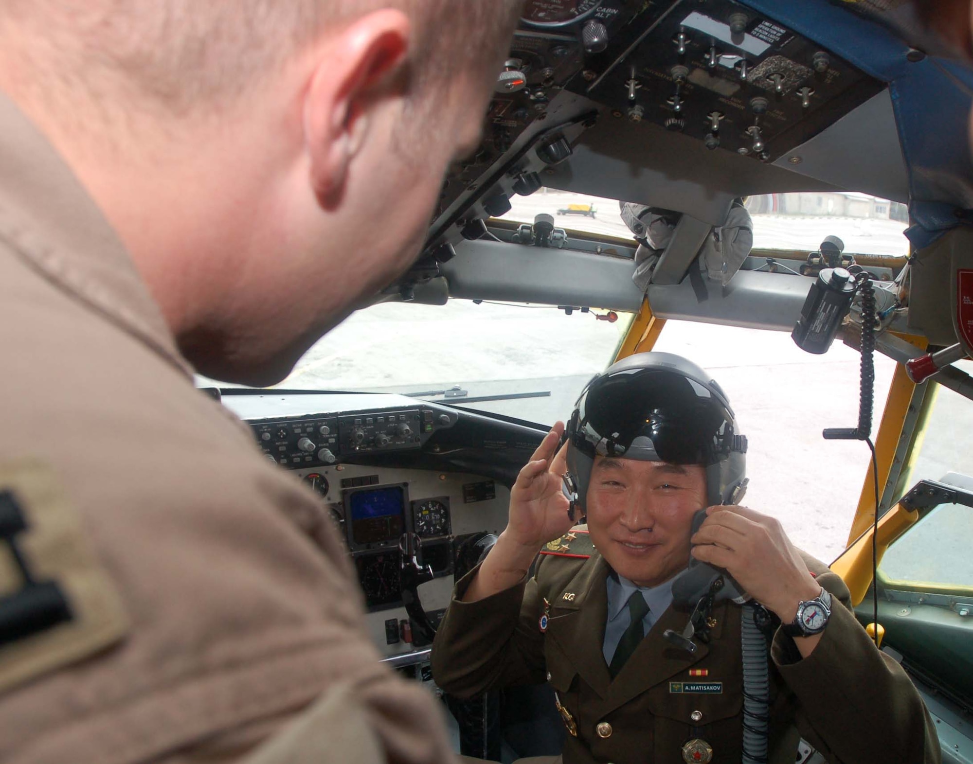 Kyrgyz Maj. Aisakiev Matisakov tries on a pilot’s helmet during a tour of a KC-135 Stratotanker at the Manas flightline Oct. 27.  Major Matisakov was part of a delegation of officials from the Kyrgyz Ministry of Defense that visited the Transit Center to share medical ideas with Airmen at the 376th Expeditionary Medical Group.  The visit was part of the partnership between Airmen at the Transit Center and Kyrgyz Ministry of Defense medical team. (U.S. Air Force photo/Staff Sgt. Olufemi Owolabi)