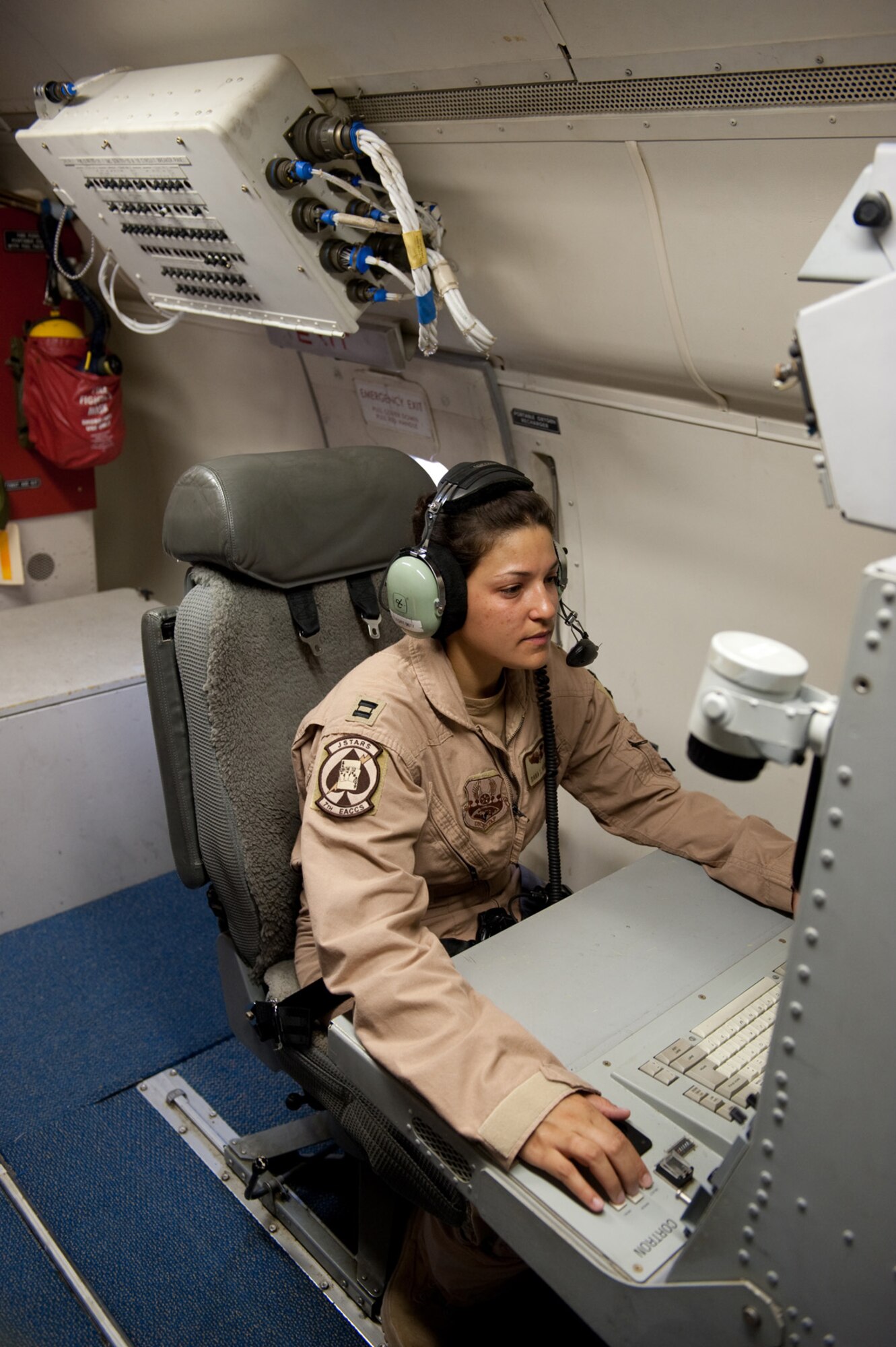 Capt. Dana Arrieta, 7th Expeditionary Air Command and Control Squadron surveillance officer, manages the radar aboard an E-8 Joint Surveillance Target Attack Radar System aircraft, Oct. 24, in Southwest Asia. The JSTARS is an airborne battle management, command and control, intelligence, surveillance and reconnaissance platform deployed in support of operations Iraqi and Enduring Freedom.  (U.S. Air Force photo/Staff Sgt. Robert Barney) 