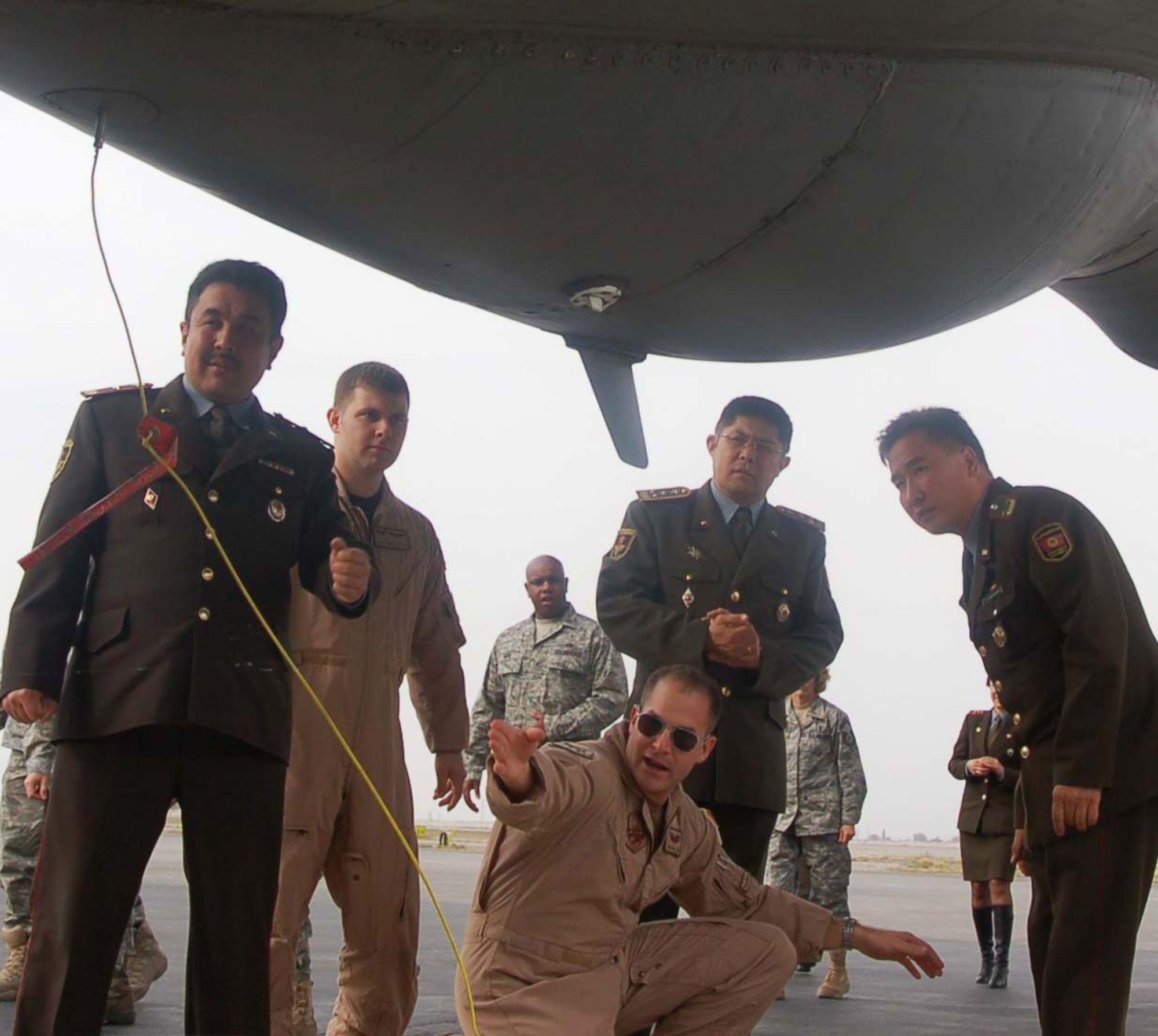 Capt. Nicholas Motlagh, 22nd Expeditionary Air Refueling Squadron, points out a part on a KC-135 Stratotanker to a team of doctors from the Kyrgyz Ministry of Defense during a visit to the Transit Center at Manas Oct. 27.  The visit was a part of the partnership between Airmen at the Transit Center and Kyrgyz Ministry of Defense medical team.  (U.S. Air Force photo/Staff Sgt. Olufemi Owolabi)