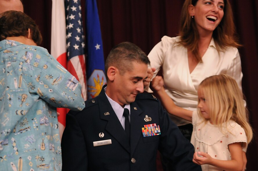 Colonel Mario Troncoso, 18th Force Support Squadron commander, has his new rank pinned on by his wife, Inanc, son Mario and daughter Smyrna Oct. 30 at the Kadena Officers' Club. (U.S. Air Force photo / Airman 1st Class Amanda Grabiec) 

