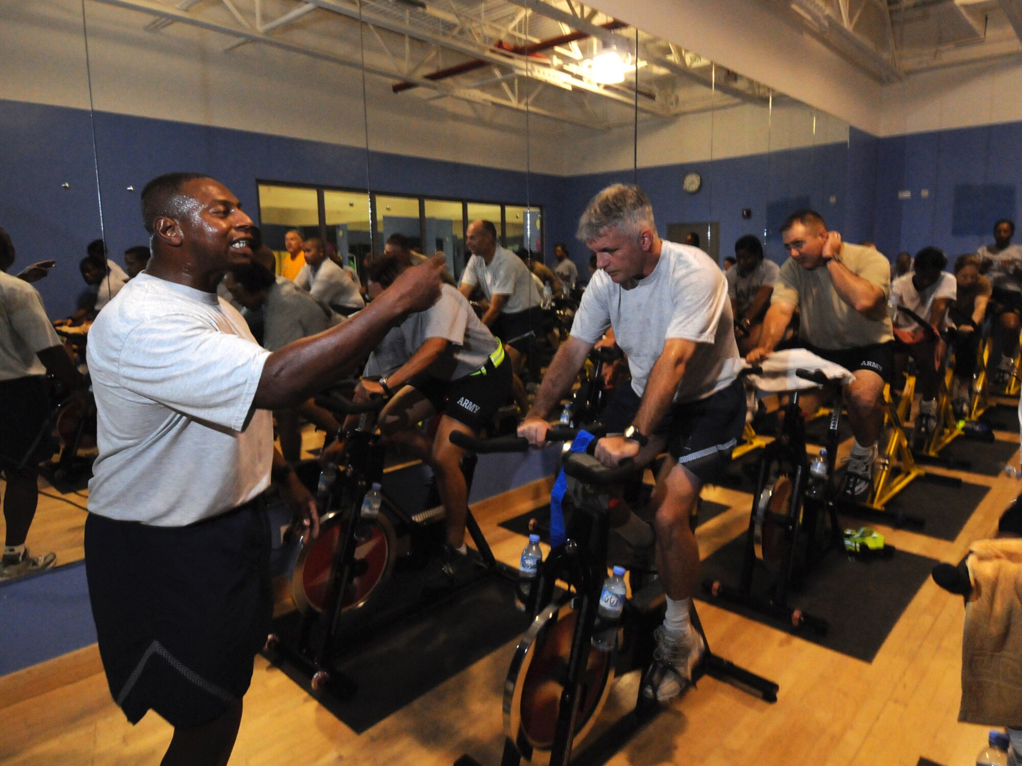 Chief Master Sgt. Lorenzo Anastasie,  379th Expeditionary Operations Group superintendent, motivates students in a spinning class in Southwest Asia, Oct. 29, 2009. Chief Anastasie offers his class, which has more than tripled in participation throughout the past six months, to deployed servicemembers three days a week. Chief Anastasie is deployed from Robins Air Force Base, Ga. in support of operations Iraqi Freedom and Enduring Freedom.
(U.S. Air Force Photo/Tech. Sgt. Jason W. Edwards)