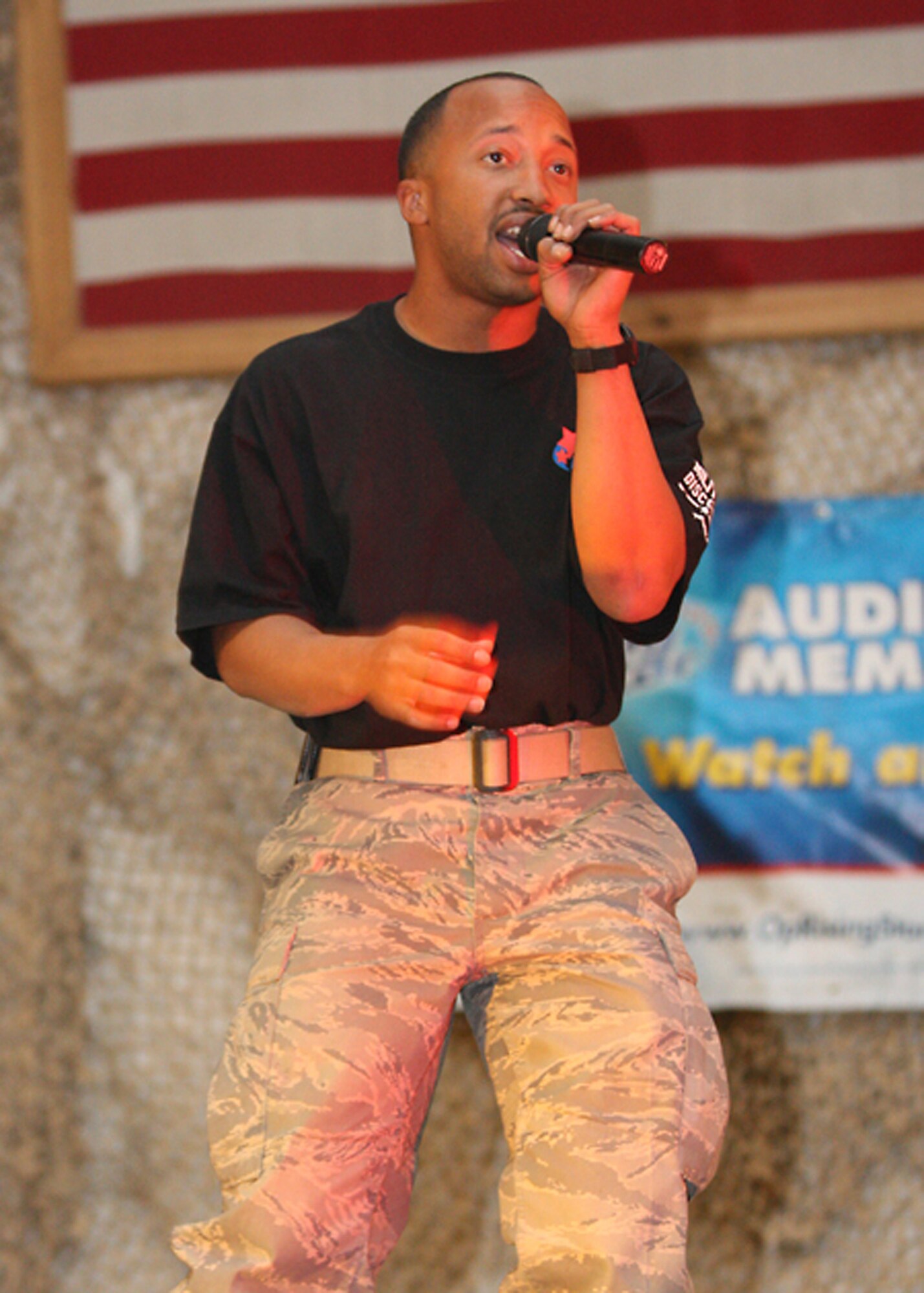 BAGRAM AIRFIELD, Afghanistan -- Staff Sgt. Kenny Dansby, a supply Airman from the 455th Expeditionary Logistics Readiness Support Squadron sings Train's "Drops of Jupiter" during the finale of Operation Rising Star, Oct. 26, 2009. ORS is a joint American Idol-type singing competition and this was the first year it was held in Afghanistan. Sergeant Dansby, a Stockton, Calif., native deployed from MacDill Air Force Base, Fla., "has been singing before he could talk,' according to his mother. (U.S. Army photo/Sgt. Maurice Luckett)