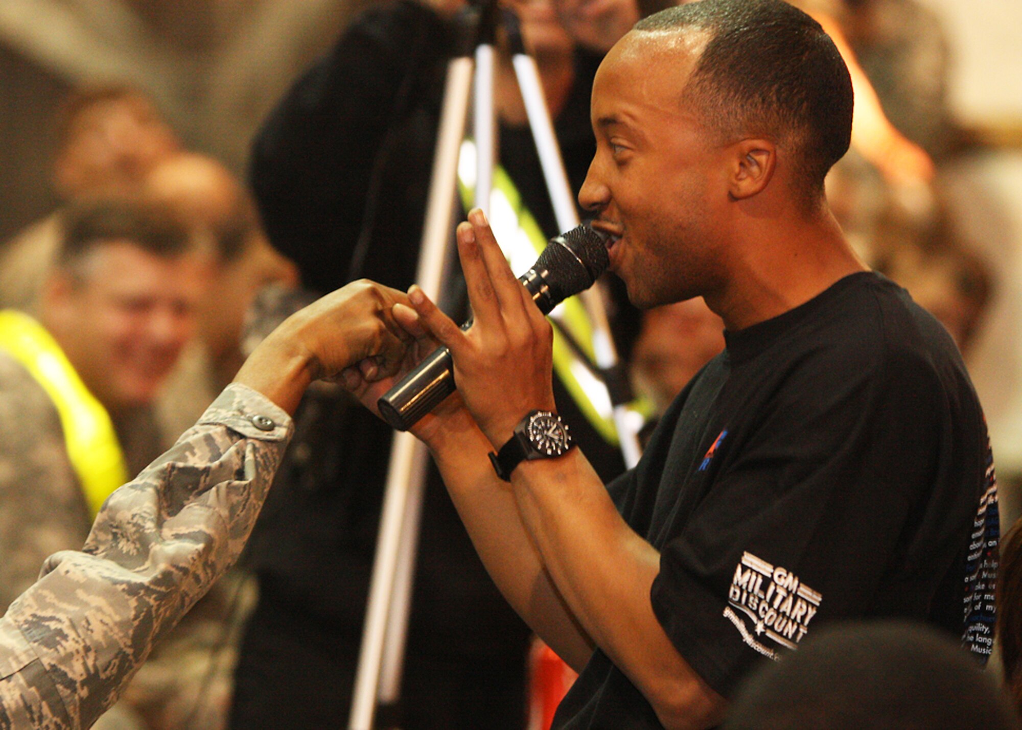 BAGRAM AIRFIELD, Afghanistan -- Staff Sgt. Kenny Dansby, a supply Airman from the 455th Expeditionary Logistics Readiness Support Squadron sings to an audience member during Operation Rising Star, Oct. 26, 2009. ORS is a joint American Idol-type singing competition and this was the first year it was held in Afghanistan. Sergeant Dansby, a Stockton, Calif., native deployed from MacDill Air Force Base, Fla., performed R. Kelly's "Bump and Grind" and Train's "Drops of Jupiter" during the finale here, winning over the audience, the judges and $500. (U.S. Army photo/Sgt. Maurice Luckett)