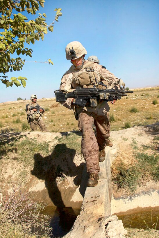 U.S. Marine Lance Cpl. Daniel Vilalobos crosses a bridge during a security patrol in the Nawa district in the Helmand province, Afghanistan, Oct. 20, 2009. Vilalobos is assigned to Bravo Company, 1st Battalion, 5th Marine Regiment.