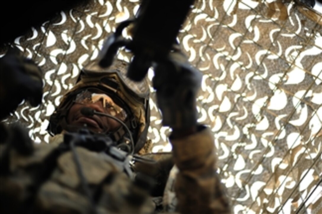 U.S. Air Force Senior Airman Patrick Kelly, with the 532nd Expeditionary Security Forces Squadron Lion Team, test fires his .50-caliber machine gun before a force protection patrol outside Joint Base Balad, Iraq, on Oct. 17, 2009.  