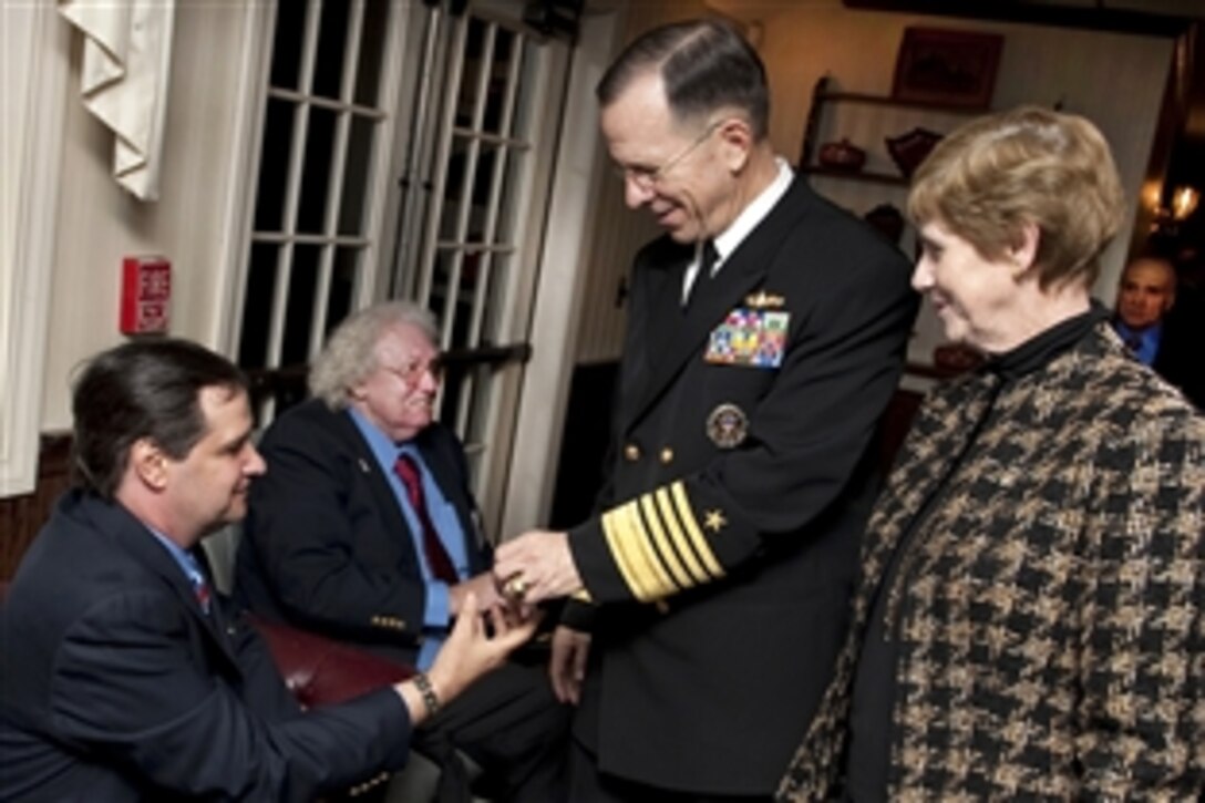 Navy Adm. Mike Mullen, chairman of the Joint Chiefs of Staff, and his wife Deborah greet formerly homeless veterans at the 1st Soldier On award ceremony in Holyoke, Mass., Oct. 29, 2009. Mullen was the first recipient of the award created to recognize a person each year who works to stem homelessness among veterans. Soldier On operates shelters as transitional homes for veterans while providing medical care, counseling and career services.