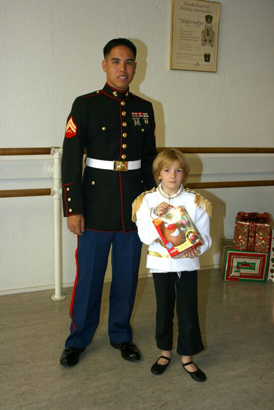 Cpl. Isaac Yuen poses with 8-year old Jackson Murphy, a dancer with the Hawaii State Ballet, and some of toys the ballet collected during a week-long drive to support Toys for Tots.  Jackson dances the role of the nutcracker prince in the ballet's 2009 production of 'The Nutcracker.'  The dancers presented several toys to the Marines Saturday, Oct 31, 2009, and are the first donations to the 2009 collection effort. This year's goal is to collect 45,000 toys to make the holiday's brighter for Hawaii's less fortunate children. (Official Marine Corps photo by Chuck Little) (Released)