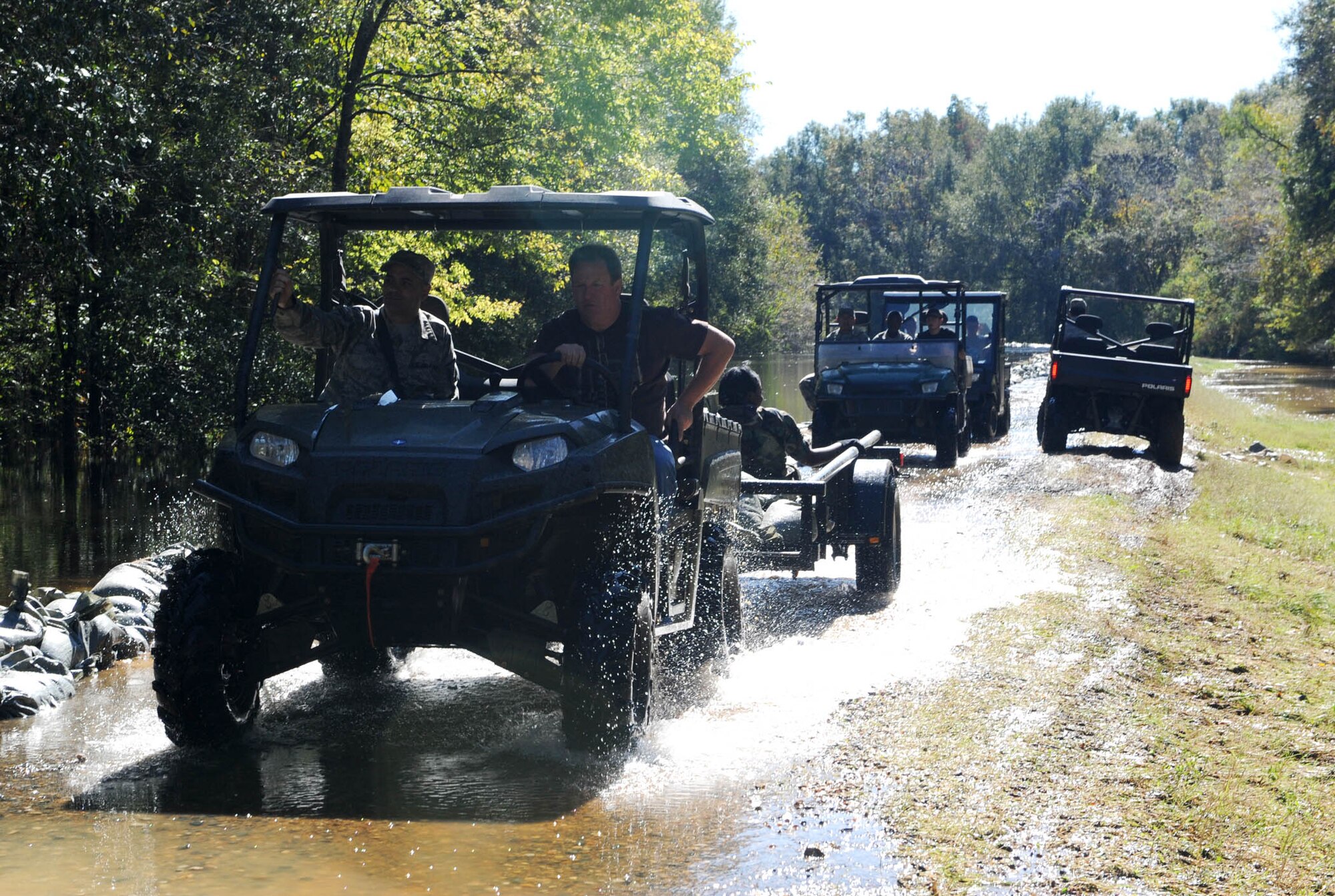 Airmen from Barksdale Air Force Base drive across and inspect a levee under threat of breach in Bossier City, La. The Airmen, at the request of state and local officials, have been working nonstop since early Saturday morning to reinforce the levee containing Red Chute Bayou. More than 300 Airmen have assisted with filling and hauling sandbags in a massive effort under immediate response authority. (U.S. Air Force photo by Staff Sgt. Mike Andriacco)