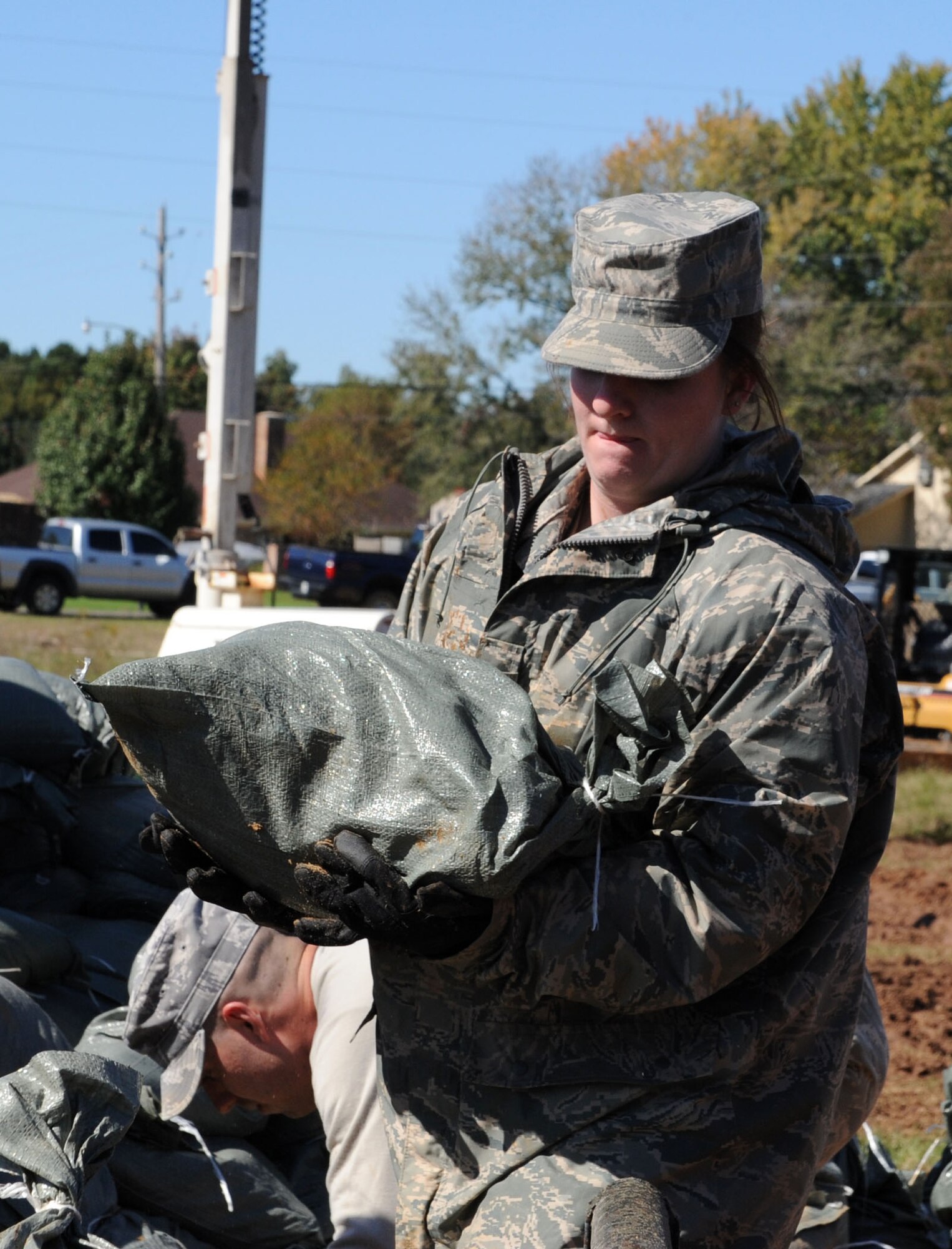 Airman 1st Class Megan Bright, from Barksdale Air Force Base's 2d Logistics Readiness Squadron, loads sand bags onto a vehicle to be delivered to a levee to hold back floodwaters in Bossier City, La. Barksdale Airmen, at the request of state and local officials, have been working nonstop since early Saturday morning to reinforce the levee containing Red Chute Bayou. More than 300 Airmen have assisted with filling and hauling sandbags in a massive effort under immediate response authority. (U.S. Air Force photo by Staff Sgt. Mike Andriacco)