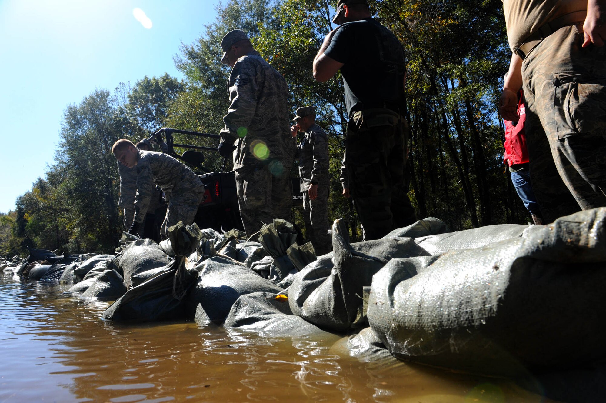 Airmen from Barksdale Air Force Base place sand bags on a levee to hold back floodwaters in Bossier City, La. The Airmen, at the request of state and local officials, have been working nonstop since early Saturday morning to reinforce the levee containing Red Chute Bayou. More than 300 Airmen have assisted with filling and hauling sandbags in a massive effort under immediate response authority. (U.S. Air Force photo by Staff Sgt. Mike Andriacco)