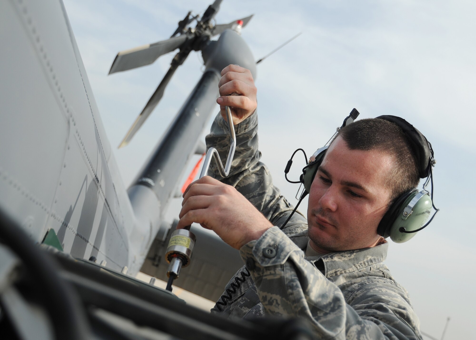 JOINT BASE BALAD, Iraq -- Airman 1st Class Micheal Griggs, 64th Expeditionary Helicopter Maintenance Unit weapons team member, torques a module into place on an HH-60G Pave Hawk as part of a maintenance check Oct. 27, 2009. The HH-60G Pave Hawk is maintained by Airmen with various specialties that include communications, navigation, engines, hydraulics, electronics, weapons systems and electronic counter warfare. (U.S. Air Force photo/Senior Airman Christopher Hubenthal)