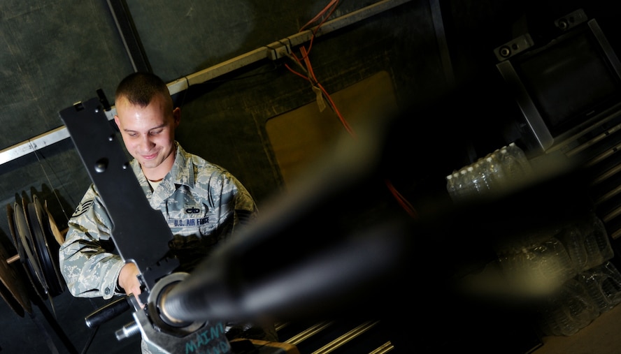 JOINT BASE BALAD, Iraq -- Staff Sgt. Gregory Boggs, 64th Expeditionary Helicopter Maintenance Unit weapons team chief, reassembles a .50 caliber machine gun for an HH-60G Pave Hawk during a maintenance check Oct. 27, 2009. The HH-60G Pave Hawk is maintained by Airmen with various specialties that include communications, navigation, engines, hydraulics, electronics, weapons systems and electronic counter warfare. (U.S. Air Force photo/Senior Airman Christopher Hubenthal)