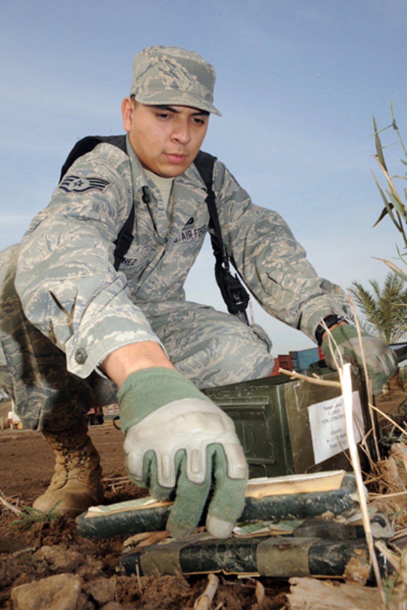 CAMP VICTORY, Iraq -- Air Force Staff Sgt. Victor Sanez, military working dog handler assigned to the Multinational Division Baghdad - Iraq, plants C4 explosives for training purposes Oct. 28, 2009. MWD handlers and their K9 partners routinely train on explosive detection to remain proficient. Sergeant Sanez is deployed from Beale Air Force Base, Calif., and hails from Rowland Heights, Calif. (U.S. Air Force photo/Tech. Sgt. Johnny L. Saldivar)
