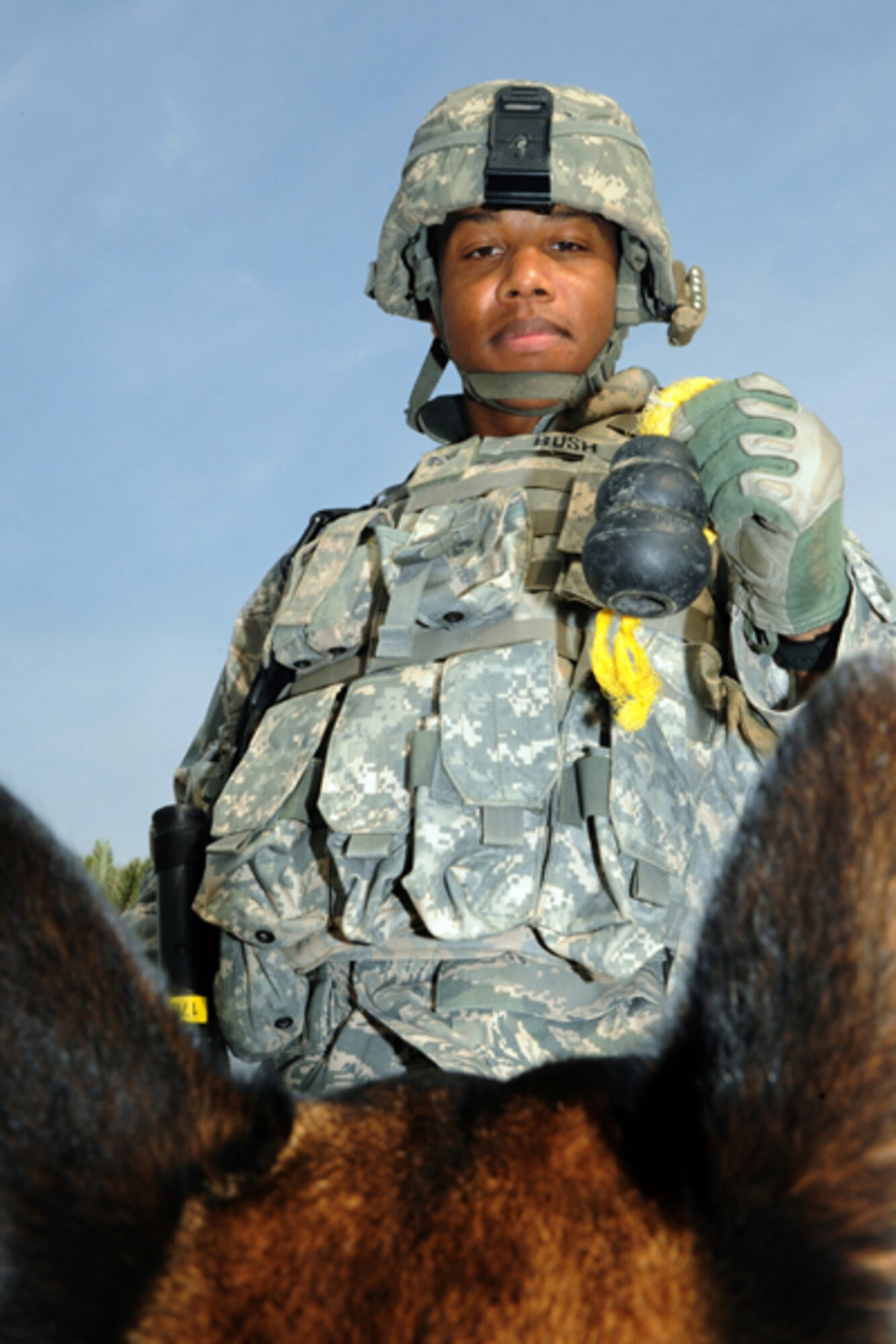CAMP VICTORY, Iraq -- Air Force Senior Airman Mark Bush, military working dog handler assigned to Multinational Division Baghdad - Iraq, motivates his K9 partner, Chukky, with a toy Oct. 28, 2009. The pair trains to ensure they remain proficient at locating explosives. Airman Bush and Chukky are deployed from Nellis Air Force Base, Nev. Bush hails from Dallas, Texas. (U.S. Air Force photo/Tech. Sgt. Johnny L. Saldivar)