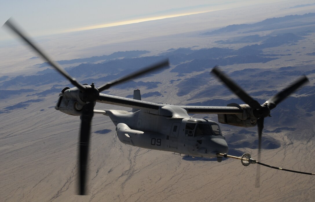 A Marine Corps MV-22 Osprey refuels midflight above the Barry M. Goldwater Range east of the Marine Corps Air Station in Yuma, Ariz., Oct. 31, 2009, during the final exercise of the Weapons and Tactics Instructors course. The tilt-rotor aircraft was refueled by a Marine Corps KC-130J Hercules plane, also participating in course. Students of the biannual course, run by Yuma-based Marine Aviation Weapons and Tactics Squadron 1, graduated Nov. 1 and will return to their units to serve as instructors on the latest aviation tactics.