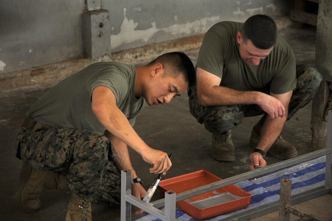 Sgt. Memora Tan (left), a La Mirada, Calif., native, and Maj. James Hickey, a Murrieta, Calif., native, with the 11th Marine Expeditionary Unit, paint a table while participating in a community service project at the Baan Ao Bor Nam School in Phuket, Thailand, Oct. 31, during a port visit. More than 20 service personnel currently deployed aboard USS Bonhomme Richard, painted tables, chairs, and interacted with the school’s students.